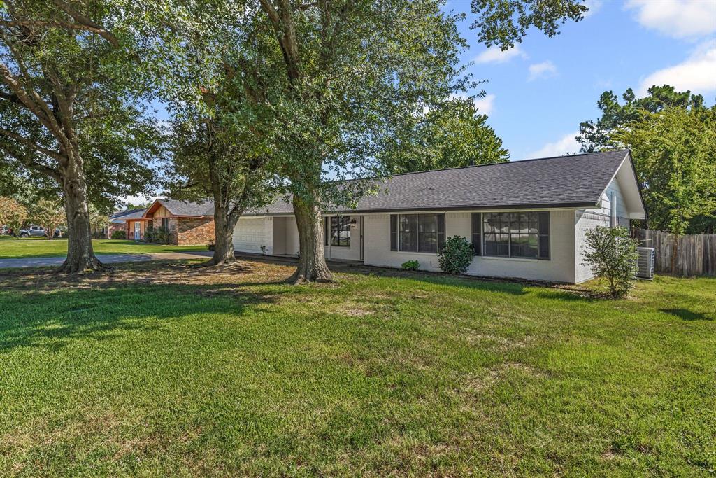 A tree-shaded lot gives tremendous curb appeal to this 3 bedroom, 2 bathroom with 2-car garage! After stepping inside the foyer, you'll notice the white-brick wood-burning fireplace in the vaulted-ceiling living room with wood beams and an eat-in dining area to the left. The kitchen includes a large u-shaped area with granite countertops, extra seating with a long breakfast bar, sleek-black subway tile backsplash, white cabinets, and stainless steel appliances. Double patio windows with a door in the living room, gives you access the shady backyard with privacy-wood fencing. Ceramic tile flooring is found in the living, dining, utility-mud room, and bathrooms. The primary bedroom comes with an ensuite bathroom that has a vanity seating area. Off the garage, you'll find a mud room and an enclosed utility area with shelving. Neutral paint colors provide a blank slate for your decorating ideas. Ceiling fans are also located in living room, dining area, and bedrooms. Park your cars in the attached 2-car garage or use the space as a game room, hobby space, or flex room. In an established neighborhood, this cute home with treed lot is also within walking distance to Lake Coleman, Coleman Park, walking trails, fishing, and picnic areas. A great home and location in town!