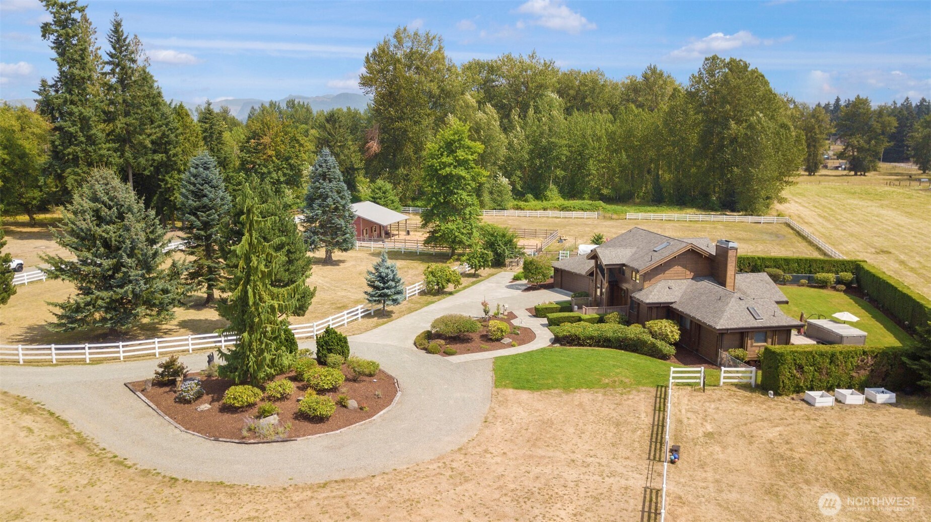 7.3-acre equestrian retreat in Enumclaw with Pan Abode cedar home and Mt Rainier views. 2,780 sq ft, 3bd/2.5ba + loft, vaulted ceilings, gas fireplace. Gourmet kitchen w/quartz, SS appliances, pantry & sunny dining. Primary suite w/gas fireplace, heated floors, back porch access. Horse barn & stables, fenced pastures, open acreage for riding/training. Barn, RV parking, landscaped grounds, circular driveway. Perfect horse property, hobby farm, or private retreat. Combines lifestyle, luxury & practicality. Ready for horses to thrive in a serene country setting with versatile outdoor space.