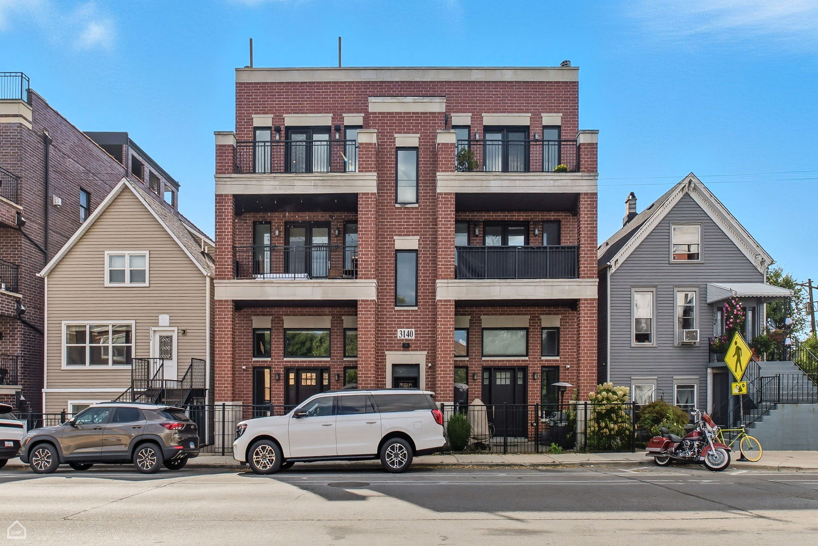 Stunning newer construction penthouse in the heart of Avondale! This light-filled 3-bedroom, 2-bath penthouse condo is an entertainer's dream, offering luxurious finishes and incredible outdoor spaces. Enjoy two prime areas for relaxing and hosting - a main-level balcony off the living room (with gas and electric hookups for grilling) and a spectacular full-length private roof deck featuring Trex-style decking, a built-in hot tub, an oversized pergola, and an outdoor TV setup. Inside, a spacious open layout offers flexible living and dining areas, tall ceilings, rich hardwood floors throughout, and a cozy wood-burning fireplace w/ gas starter. The chef's kitchen impresses with floor-to-ceiling soft-close shaker cabinetry, quartz countertops w/ breakfast bar, Bosch appliances, subway tile backsplash, under-cabinet lighting, and a vented range hood. The expansive primary suite includes a fully organized walk-in closet and luxurious en-suite bath w/ dual vanity and a walk-in shower w/ stone surround and premium fixtures. Two additional bright bedrooms provide excellent closet space and versatility. Additional highlights include an organized laundry closet, central heat and air, and flexible upstairs office or fitness space leading to the roof deck. Garage parking and extra storage are included in the price! This well-managed and maintained six-unit building is currently 100% owner-occupied (rentals allowed) and pet-friendly. Ideally located in vibrant Avondale near Kuma's Corner, Beer Temple, Brands Park, the Blue Line, with easy access to 90/94 and all the great amenities throughout Logan Square, Roscoe Village and and Irving Park.