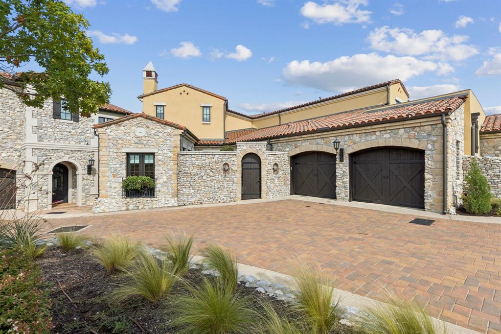 Experience the perfect blend of Old World charm and modern luxury in this stunning Spanish-style waterfront townhome, located in the highly sought-after Westlake Entrada community. Behind a beautiful stone courtyard entrance, you’ll find lush landscaping with mature potted trees leading to the private front door. This thoughtfully designed home offers a rare primary suite on the main floor, complete with walkout access to a covered balcony that also connects to the family room—ideal for seamless indoor-outdoor living. The light-filled kitchen is a chef’s dream, featuring Sub-Zero and Wolf appliances, abundant natural light, and elegant French doors that open to the outdoors. A private main-floor study offers a quiet space and a charming Juliet balcony for added ambiance. Upstairs, two generously sized en-suite bedrooms provide comfort and privacy. The basement floor includes an additional bedroom, full bath and a spacious game room with a wet bar—perfect for entertaining. Step out onto the covered veranda overlooking tranquil water views, mature landscaping and enjoy the additional large side area, ideal for gardening, lounging, or for pets. Westlake Entrada is a picturesque, lock-and-leave community inspired by a European village, offering refined living with everyday convenience. Enjoy close proximity to DFW Airport, LifeTime Fitness, and Southlake Town Square. Families have access to top-rated school options including Carroll ISD and Westlake Academy. This exceptional home offers the best of both beauty and function in one of the most desirable neighborhoods in Westlake.