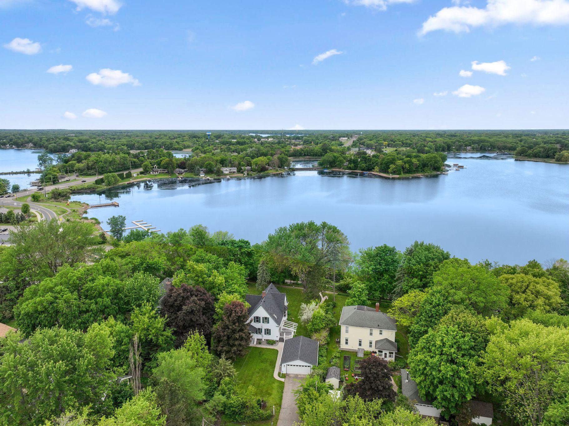 Experience exceptional sunset views from this distinguished Victorian residence situated on North Center Lake. Located on Historic Summit Avenue, the property offers convenient access to local restaurants, parks, and heritage sites in the center of America’s Little Sweden.The architect thoughtfully designed this home to highlight lake vistas with an inviting front porch, a sunroom, a side deck, and a landscaped, park-like yard. Notable architectural features include a butler’s pantry, a secondary staircase, solid oak pocket doors, nine-foot ceilings, a parlor, the grand central staircase, a clawfoot bathtub, decorative fireplaces, and the “lake room” featuring a window seat for optimal viewing.The property has been exceptionally maintained, with more than $125,000 invested in recent upgrades. Improvements include a new roof, leaf guard gutters, modernized windows, siding, shutters, window well covers, renovated side and back porches, a new garage door, NEST system, storm doors, sidewalks, appliances, and shower. Additionally, the humidifier, central air conditioning, and furnace were replaced about 2012.This property includes a 2nd property with 50' on North Center Lake which is known for its exceptional beauty and good fishing. It is part of the Chisago Chain of Lakes with over 5,000 acres. There is a city dock with easy access to restaurants for boaters.This residence presents a rare opportunity to experience refined lakefront living, as enjoyed by the current owners for more than five decades.