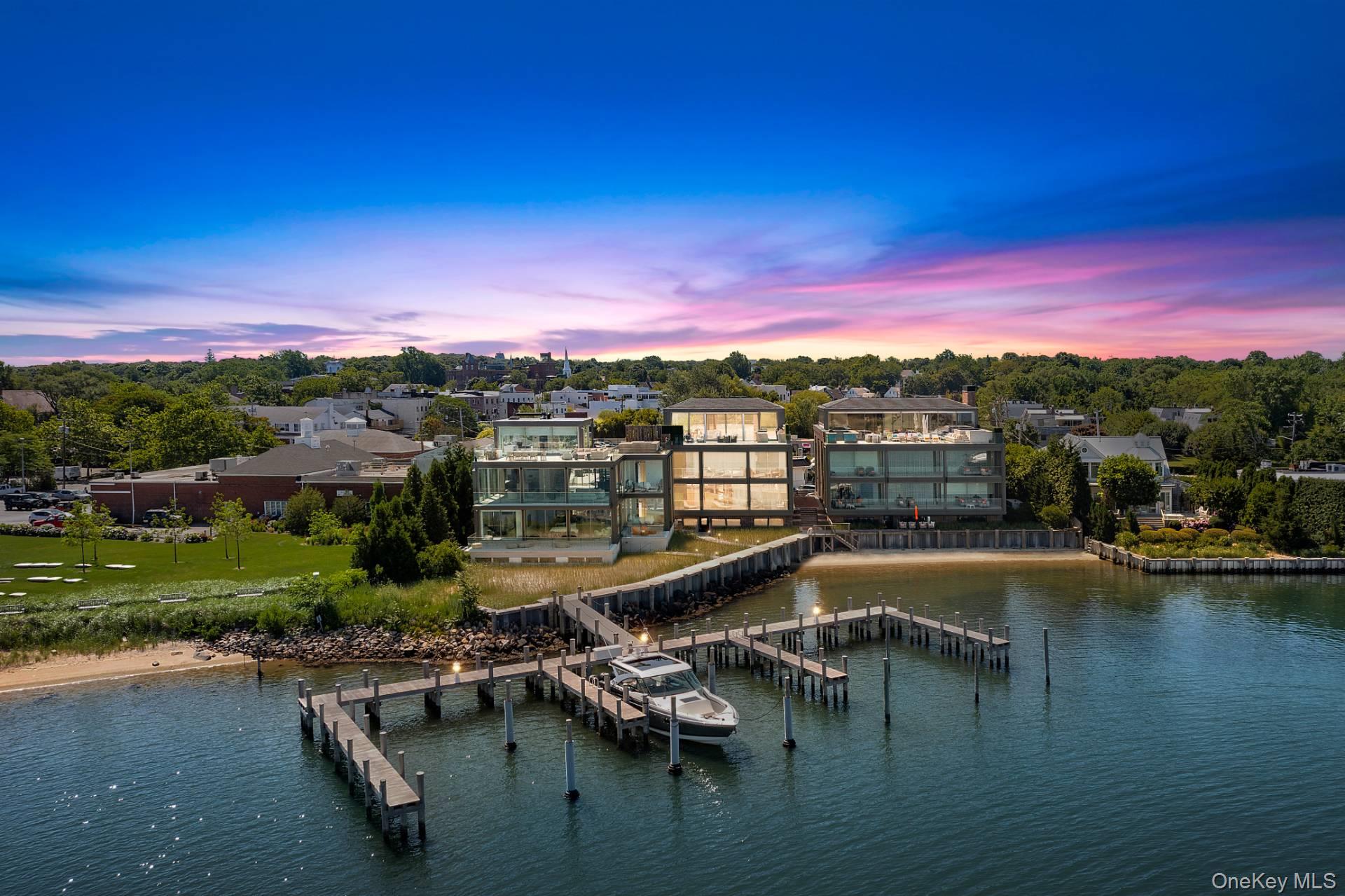 The Pinnacle of Sag Harbor Waterfront LivingThis 11,723 SF+/- masterpiece redefines harbor water front luxury living. A collaboration between Andre Kikoski, Sofia Joelsson, and Ed Hollander, this 4-level residence sits on 250' of direct frontage on Sag Harbor Cove, featuring a private beach and an exclusive deep-water marina with two 60' slips. The Residence is defined by floor-to-ceiling glass and seamless indoor/outdoor transitions, the home features 8 bedrooms, 9.5 bathrooms, and an elevator serving all levels. Living spaces are light-filled, open-concept layout with wide-plank flooring, a sculptural floating staircase, and double-height foyers. The chef's kitchen embraces only the best: White Calacatta marble, custom charcoal Ecolak cabinetry, and a suite of Miele, SubZero, and Gaggenau appliances. The primary suite is situated in its own private wing featuring dual walk-in closets, panoramic water views, and a spa-bath clad in fluted Fior De Bosco tile and Black Cosmic granite. The guest quarters are elegant designer en-suites appointed with Zebrino marble, Canaletto walnut, and molten brass accents. Additional amenities include a Rooftop Oasis with an expansive terrace and a full outdoor kitchen, BBQ, and dining all overlooking Sag Harbor Cove. Sunsets provide moving artwork throughout the seasons. A private gym with Technogym equipment, 4-car underground garage, and a Rolls-Royce-engineered backup power system. All of this mere steps from Sag Harbor's Main Street galleries and fine dining. This isn't just a home; it's a masterclass in Hamptons engineering. From the deep-water docking to the rooftop with pool potential, extraordinary sunsets, every inch has been intentionally curated for capacious hosting and tranquil privacy.