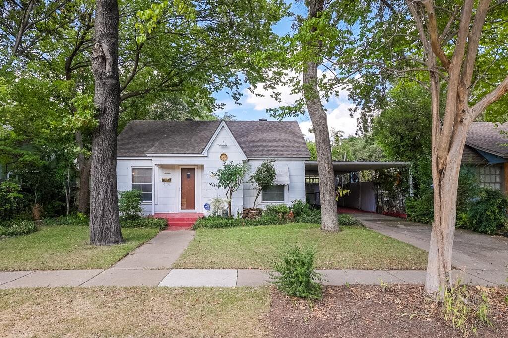 This beloved family home, cherished by the same family since 1942, is ready for your vision to revive its timeless charm. The front yard features mature trees, carefully curated landscaping, and an inviting sidewalk. Inside, you’ll find two cozy bedrooms and two full bathrooms, one recently updated with a walk-in shower, built-in seating, and a medicine cabinet. The spacious living room seamlessly connects to a dining area, paired with a well-equipped kitchen boasting granite countertops and a large pantry. The primary bedroom offers a flexible bonus room, ideal for a home office, with direct backyard access. A warm family room off the kitchen includes a wood-burning stove. Flooring consists of carpet, wood laminate, and tile, with original wood floors beneath some carpet, according to the owner. A one-car covered carport with direct home entry provides shelter from the elements, and a large utility room offers convenient backyard access. The serene backyard retreat features mature trees, diverse plants perfect for gardening, a covered porch, a shaded seating area, and two electrified outbuildings for ample storage. The gas water heater and HVAC system were both replaced in 2019. Ideally situated near Sylvania Park, local dining, and shopping, this home promises convenient, comfortable living.