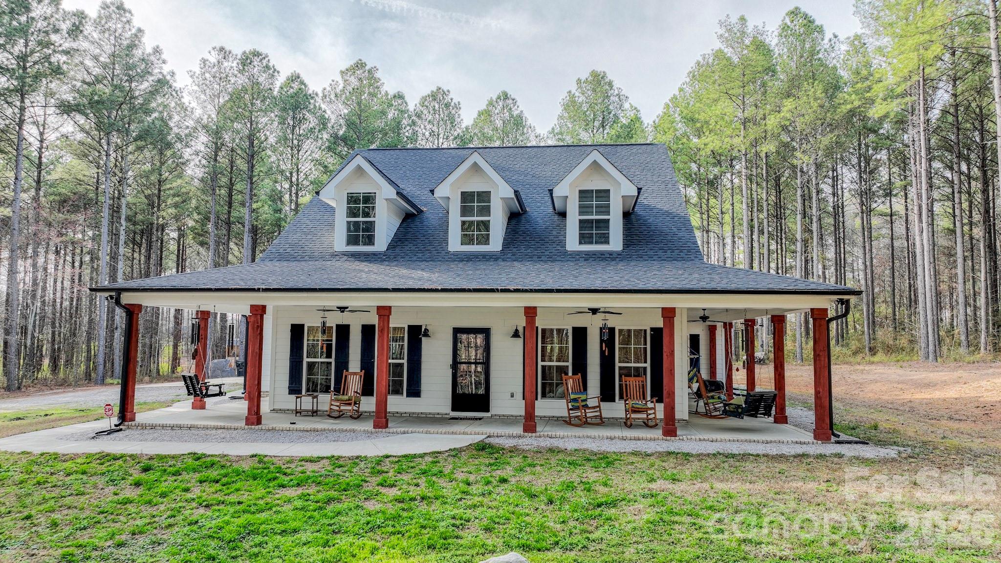 Stunning farmhouse-style home on a beautiful, wooded lot offering 3,394 sq ft of beautifully designed living space! This 3-bedroom home with 3 car garage includes an office with closet and massive bonus room that combines comfort, style, and functionality in every detail.Enjoy peaceful mornings on the wrap-around front porch and relaxing evenings on the rear patio overlooking a picturesque, wooded lot that creates a breathtaking drive into your new home.Inside, the open-concept kitchen flows seamlessly into the living and dining areas — perfect for entertaining. The kitchen features abundant cabinet space, a spacious pantry, and a massive island with prep sink. The first floor showcases durable LVP and tile flooring throughout.The living room is anchored by a stunning stone gas fireplace with a cedar mantle and includes a convenient media storage closet. A large laundry room offers ample cabinetry for exceptional storage and everyday convenience.Upstairs, the massive bonus room includes a dedicated media area and a full bath, making it ideal for movie nights, guests, or a private retreat. The luxurious primary suite boasts a large tiled shower, along with upgraded sinks, faucets, light fixtures, and mirrors for a truly elevated feel.Located in the desirable New Salem/Piedmont School District and convenient to Monroe, Oakboro, and Locust, this home offers the perfect balance of privacy and accessibility.Seller is leaving behind the following with the sale of the property; furniture, Dining Room Table with chairs, Barstools at Kitchen Island, Wine Cabinet, generator, zero turn John Deere Mower, all appliances including refrigerator, washer/dryer, Tv's and tv mounts, tv projector upstairs, outdoor furniture, sauna, work bench and generator.Don’t miss this exceptional opportunity — call today to schedule your personal tour!Also check out the vacant lot listing next door, MLS 4352145. This is a 2.09 acre lot available for purchase. Perc testing already complete.