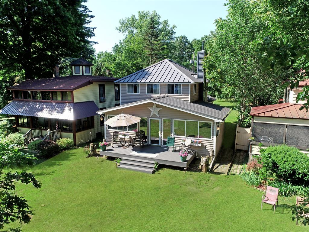 Welcome to your island oasis on highly sought-after Case's Island in the center of Lake Fenton. Nestled on a generous .5-acre lot with prime park views, this meticulously maintained 3-bedroom, 1.5-bath home combines classic cottage charm with modern comfort. The open floor-plan layout features newer hardwood flooring throughout. The full bath is updated & features an oversized shower, a jetted soaking tub, and upgraded finishes. Enjoy all-season comfort with central air, a forced-air LP gas furnace, and a cozy wood stove--perfect for crisp Michigan evenings. Step out to the screened-in porch to look over the park area with sweeping lake views, or out to your back deck overlooking your enormous private yard.  Call for private showing today! Buyers agents must take clients by boat.