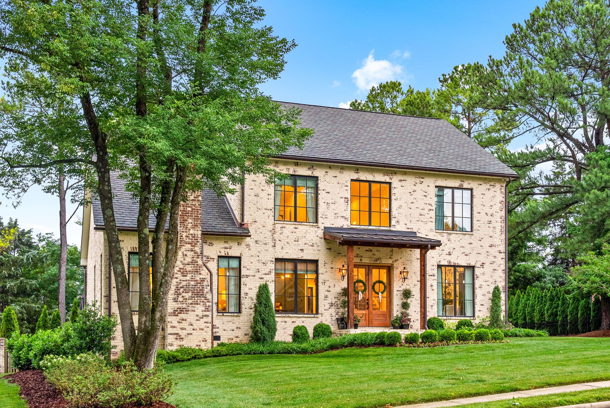Relaunched and now offered at its professionally appraised value, this distinguished Stonehenge residence delivers an exceptional blend of luxury, craftsmanship, and thoughtful design. Lush, architect-curated landscaping, natural gas lanterns, 6" OrnaMetal copper gutters, and elegant cedar garage doors set an elevated tone from the moment you arrive. Inside, the home unfolds with sophisticated flow—an open living room and eat-in kitchen, a formal dining room, and a dedicated home office. The chef’s kitchen features Wolf/Subzero/Cove appliances, a 6-burner Wolf gas range with infrared griddle, quartzite countertops, a striking vent hood, walk-in pantry with Elkay bottle filler, Subzero wine storage, and a Scotsman nugget ice maker. A stunning sunroom expands the living experience with two full walls of glass accordion doors that open the length of the room in both the living room and the patio, create seamless indoor/outdoor living. The main-floor primary suite offers a limestone fireplace, vaulted ceilings, dual walk-in closets, and a spa-level bath with heated tile floors throughout, including a steam shower. Upstairs are three generous bedrooms with walk-in closets, a Jack-and-Jill bath, an additional full bath, an expansive bonus room over the 3-car garage, and a second laundry room. The tiered backyard provides multiple terraces for elegant entertaining, dining, or relaxation. A rare luxury offering in one of Clarksville’s most coveted communities.