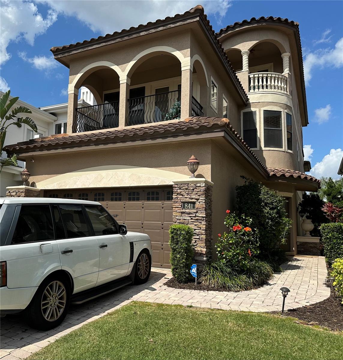 Welcome to this stunning 3-story, 8-bedroom, 5-bathroom home, nestled in the prestigious Reunion West Village, offering breathtaking views of the Jack Nicklaus-designed golf course. This residence is designed for both relaxation and entertainment, featuring spacious bedrooms, elegant living spaces, and high-end finishes throughout. The open-plan layout seamlessly connects the kitchen, family room, and dining area, creating the perfect flow for family gatherings and entertaining guests. Step outside to your outdoor living area where you can enjoy your outdoor kitchen, take a dip in the pool, or relax in the spa. This 3-story home has an elevator which adds convenience and ease, allowing effortless access to all levels. The expansive primary suite, located on the second floor, is a true retreat. It includes a private balcony with panoramic views of the greens, a large walk-in closet, and an en-suite bathroom complete with a soaking tub and a walk-in shower. This property is not only a dream home but also a fantastic investment opportunity, as short-term rentals are allowed.  Additionally, this prime location is just a short drive from Orlando's theme parks, the Orlando International Airport, and Florida's beautiful beaches. This is a sale through the Bankruptcy Court.