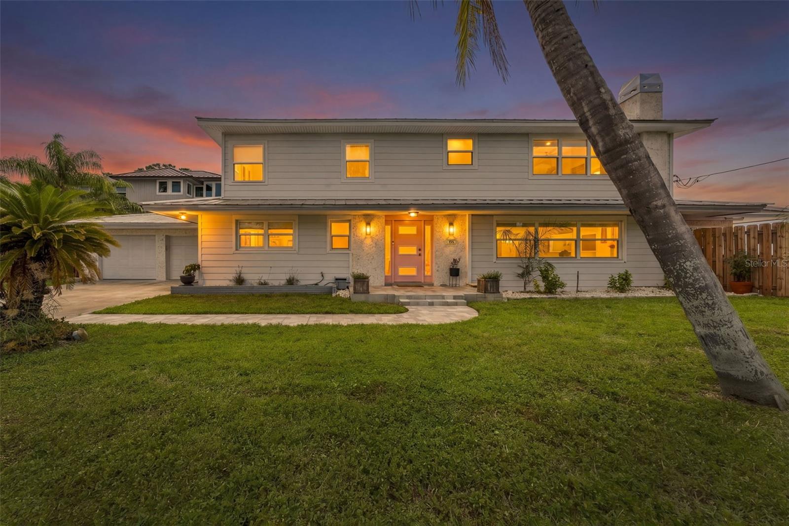 Move-in ready waterfront retreat with expansive Gulf, ocean, and Intracoastal Waterway views, perfect as your dream home or a turnkey Airbnb investment. Sold fully furnished with no HOA and no short-term rental restrictions. This fully updated, open-concept home offers 6 bedrooms, 5 baths, and 3,132 square feet with wood cabinets, granite countertops, and a walk-in pantry. The spa-like primary bath features a frameless glass walk-in shower with water views. Outside, enjoy a private pool and spa, a covered lanai with outdoor dining, an expansive paver deck along the seawall, and your own private dock — all framed by lush tropical landscaping. A fireplace and rare two-car garage with full bath complete the package. Set in the heart of golf-cart-friendly Palm Harbor, you're just a short drive from charming restaurants, shops, and the pristine beaches of Honeymoon Island. Move right in and make it your own."