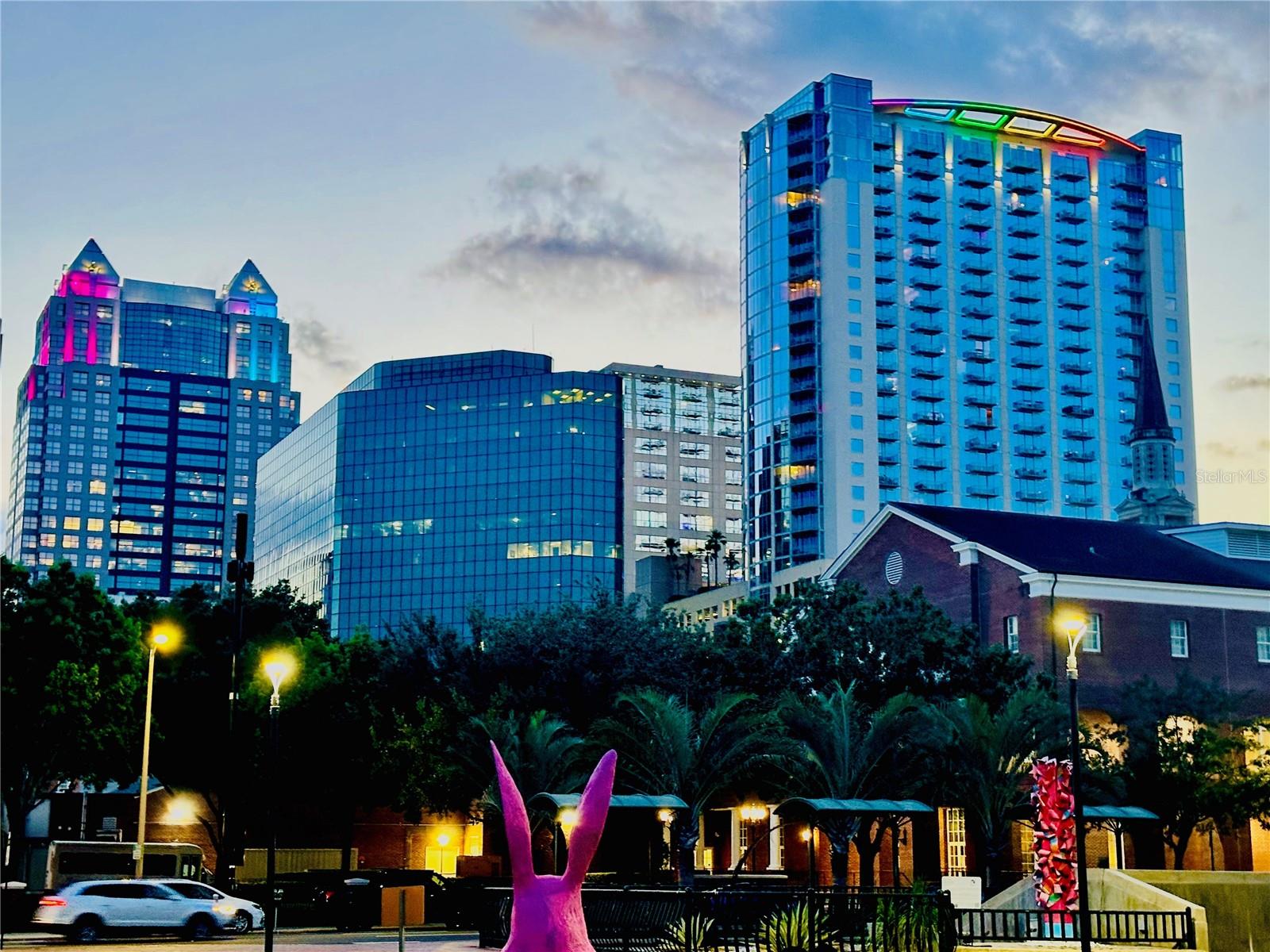 Experience elevated urban living at Solaire at the Plaza—one of Downtown Orlando’s most iconic high-rise residences. Perfectly positioned in the heart of the city’s Financial and Entertainment Districts, this contemporary tower places you just steps from the energy of Church Street and Orange Avenue, offering unmatched walkability and convenience.Unit 1415 is a stunning corner 2-bedroom, 2-bath residence featuring approximately 1,212 square feet of thoughtfully designed living space. This highly sought-after split floor plan offers optimal privacy, with each bedroom positioned on opposite sides of the unit—ideal for both primary living and guests. Floor-to-ceiling glass wraps the entire living area, flooding the space with natural light and showcasing breathtaking panoramic skyline views of Downtown Orlando, including landmarks such as Lake Eola Park and the surrounding cityscape.The open-concept design seamlessly connects the kitchen, dining, and living areas, creating a modern and functional layout perfect for both entertaining and everyday living. Step out onto your private balcony to take in vibrant sunsets and the city lights below—true high-rise living at its finest. This unit also includes two secured parking spaces, a rare and valuable feature in the downtown core.Built in 2007, Solaire at the Plaza is a 29-story luxury condominium known for its sleek architectural design and signature illuminated crown that defines the Orlando skyline. Residents enjoy a full suite of amenities located on the 10th-floor terrace, including a resort-style pool, state-of-the-art fitness center, clubroom, media lounge, and outdoor grilling areas surrounded by lush landscaping.Additional features include 24-hour concierge and security, controlled access entry, and a gated parking garage, providing both comfort and peace of mind. With immediate access to SunRail, LYMMO, major highways, and premier destinations like Kia Center and Dr. Phillips Center for the Performing Arts, this location is ideal for professionals and investors alike.Whether you’re seeking a sophisticated primary residence or a high-demand investment property, Unit 1415 at Solaire at the Plaza delivers the perfect combination of location, design, and lifestyle in the heart of Downtown Orlando.
