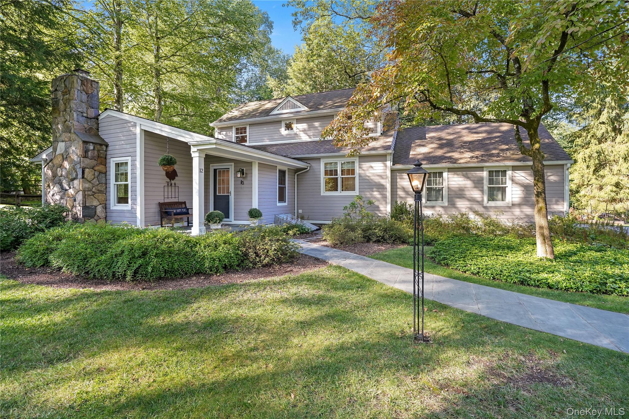 Fabulous opportunity to own this eco-friendly home in Twin Lakes Village. This beautifully maintained Cape Cod is situated on a picturesque lot with mature landscaping and gorgeous curb appeal. Enter the gracious first floor and find a vaulted living room with exposed beams featuring a charming stone fireplace with slate hearth. There is an open flow to the dining area and kitchen with hardwood floors throughout and large windows for optimum sunlight. The kitchen boasts stainless steel appliances, granite counters, tumbled marble backsplash and easy access to your private stone patio. The backyard is fenced and includes stone walls and a slate patio, great for entertaining. Continuing on the first floor is the Primary bedroom with an en-suite bathroom and a walk-in closet. There are two more bedrooms with a full bathroom on the second floor. This is an energy-efficient home that has been updated to geothermal heating and cooling, two electric charging options in the attached garage, a full house standby generator, water softener system and deeded lake rights to Oscaleta Lake and also close to Mountain Lakes Park.  The Two Lake Club IS A FIVE MINUTE WALK and includes a beach, docks, playground, kayak storage and a picnic area with seating.  Close to shops, schools, commutable highways, trains and more.