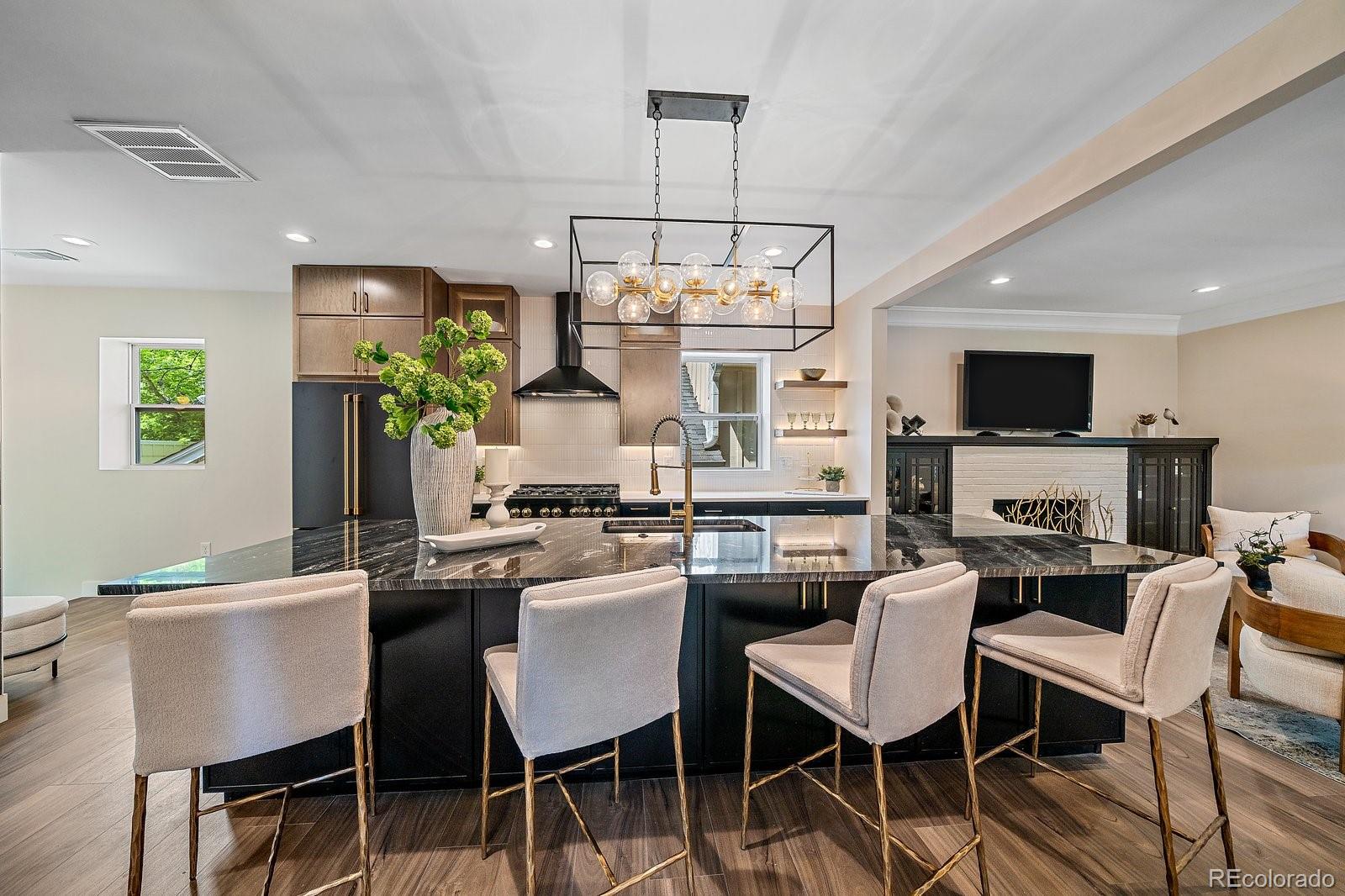 Tucked into the heart of Denver’s coveted Hale neighborhood, 805 Elm Street is a jaw-dropping fusion of timeless craftsmanship and bold design. This full-brick stunner keeps its original soul refurbished built-ins, the charming front door, and a wood-burning fireplace while elevating every inch with show stopping updates.Inside, stained maple cabinetry wraps the perimeter, contrasting perfectly with a sleek black island that seats six, finished in black granite and gold hardware. Black appliances and chopstick tile tie it all together, while mid century lighting adds that effortlessly cool vibe.The kitchen features premium appliances, including a ZLINE Autograph Collection 36” 6-burner dual fuel range, Café matte black counter-depth fridge and built-in microwave drawer oven, Bosch matte black dishwasher, and a Zephyr matte black hood, all with brushed gold accents.The main level bathroom is a spa-like retreat: emerald green tile, black glass freestanding tub, and a European-style shower with dual heads. It’s bold. It’s breathtaking. And it’s just the beginning.Downstairs, the lower level transforms into a speakeasy-style lounge, complete with two more bedrooms, two full bathrooms, and flexible space for entertaining, workouts, or play. Whatever your lifestyle demands. A sleek Zephyr wine cooler completes the basement wet bar setup.A brand new oversized 2-car garage (24’8” x 24’8”)Features we love:Full brick exterior with preserved vintage charmDesigner kitchen with ZLINE, Café, Bosch & Zephyr appliancesEmerald-tiled spa bathroom with dual shower & tubSpeakeasy-inspired bar with wine coolerBrand new 24’8” x 24’8” 2-car garageMid Century lighting throughoutPrime Hale location near parks, shops & diningMain floor includes 2 spacious sun-filled bedroomsThis home is where old-school charm meets bold, modern living. Come see what the buzz is all about.