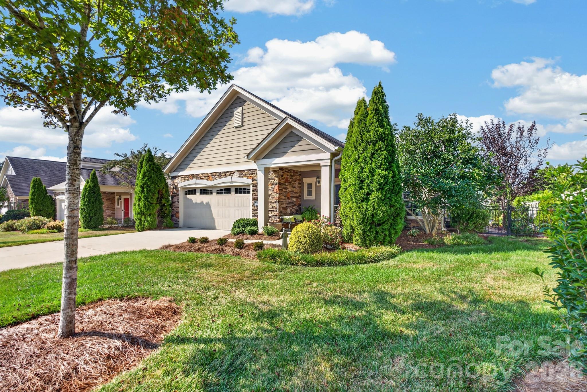 Beautifully updated home in The Courtyards of Marvin.  The Courtyards community offers Clubhouse with activities, pool, sidewalks, relaxing walking trail with pergola & sitting area, 2 ponds, lawn service, private courtyards, lush pristine landscaping and friendly residents. This home offers Hardwood floors, new carpet, archways,New crown molding,New microwave, 1 year old water heater.  Serene courtyard with completely new  landscaping,  water feature & Landscape lighting.  Large master closet, Gas heat, Gas Logs, Gas water heater. Primary Bath has  HUGE zero entry shower . Primary Bedroom leads to covered outdoor sitting area with privacy. 2.5 car garage ( no more tight spaces for 2 cars). Exterior scheduled to be Painted in October 2026. Move in ready.  Low Union County Taxes. Just off Providence Road for easy access to shopping. Historic Waxhaw a mile away..  A must see Pristine Property at an affordable price.