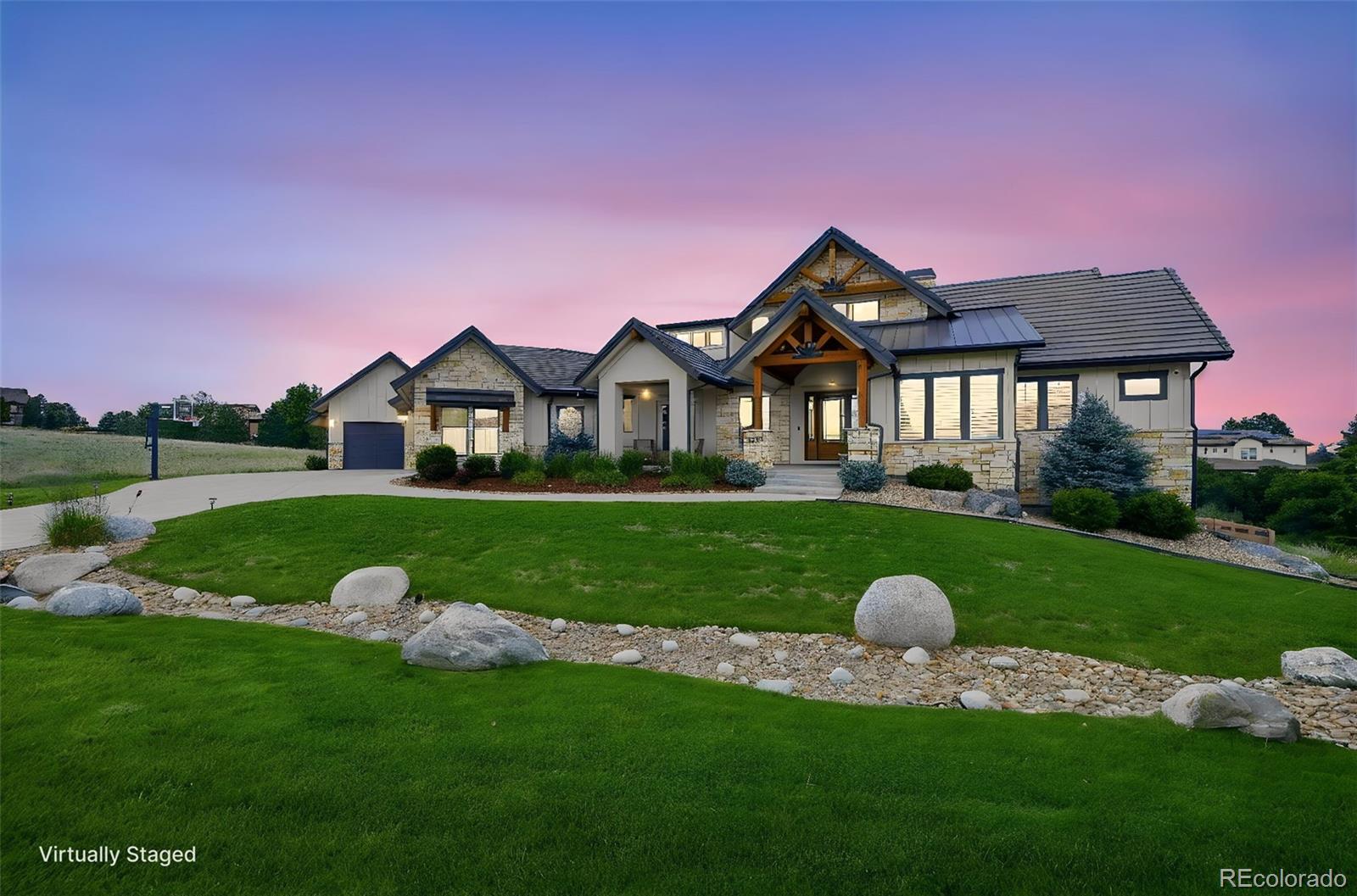 Prepare to be impressed by this exquisite ranch-style masterpiece in the renowned golf course community of Pradera.  This stunning home was custom built in 2020 and showcases unparalleled craftsmanship, exceptional quality and luxurious finishes throughout. Stunning curb appeal with distinctive wood beams and a large covered front porch situated at the end of a quiet culdesac offering  privacy and spectacular views in every direction. Effortless indoor-outdoor living is designed to capture Colorado’s natural beauty with vast covered outdoor living areas, a custom outdoor kitchen, composite decks with gorgeous tongue and groove vaulted ceilings and a dry below system covered patio. Inside, beautiful hardwood floors, grand vaulted ceilings, refined finishes, and curated details complement the spacious floor plan. The impressive gourmet chef’s kitchen is anchored by top-of-the-line appliances, oversized center island, beverage station, custom Tharp cabinetry, large pantry and custom farm sink. Enjoy entertaining guests and hosting intimate dinner parties in the formal living and dining spaces, while relaxation and ease await in the family room, complete with a custom fireplace and large sliding doors leading out to the deck. Retreat to your main-floor primary suite with patio access, dual walk-in closets, a spa-inspired ensuite bath and steam shower. Additional features include a main-floor home office (which could be a 3rd main level bedroom) an oversized 5-car garage, exposed beams, spacious laundry room with and a dedicated mud room with custom built-ins. The finished walkout basement is fantastic featuring three very spacious bedrooms with direct access to either a ¾ bath or a jack and jill, wet bar, access to the covered patio and hot tub, a gaming area and a lowered fitness area (sunk and wired for a golf simulator!) that sets the tone for evenings that linger. Pradera is not just a neighborhood but a lifestyle and this home is truly what dreams are made of!