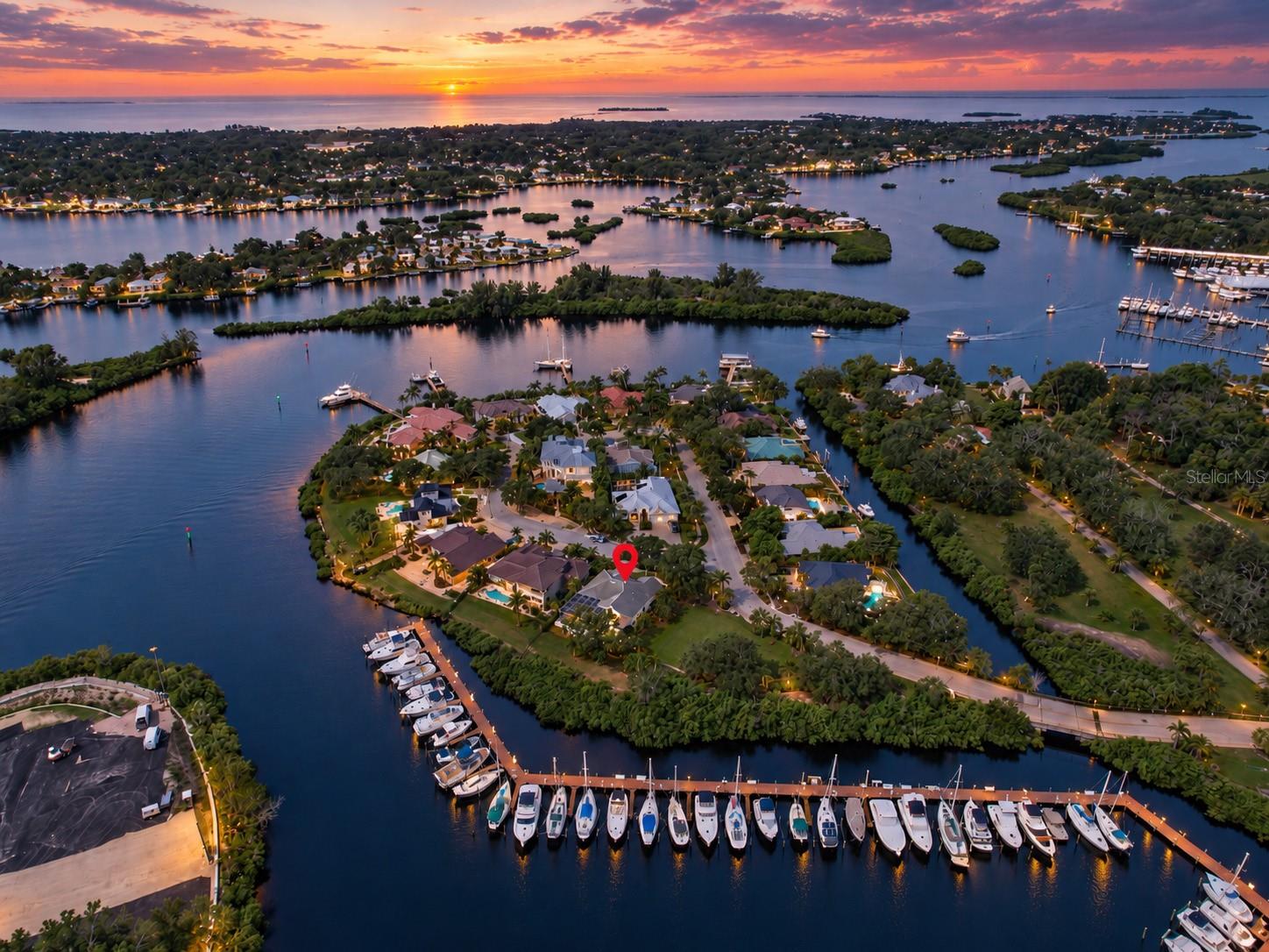 A RARE VALUE IN ANCLOTE ISLES - WATERFRONT LIVING IN ONE OF TARPON SPRINGS' MOST DISTINCTIVE ENCLAVES. This beautifully maintained 3-bedroom, 2-bath residence presents an exceptional opportunity to experience the Anclote Isles lifestyle at a price rarely available within this intimate waterfront community. Set along a peaceful bayou with approximately 70 feet of waterfront and expansive views across the water and neighboring marina, the home captures the scenery that makes this location so special - tranquil sunrise skies, coastal breezes, boats passing through the protected waters, and the unmistakable feeling of living at the edge of the Gulf Coast. With approximately 2,018 sq ft, this thoughtfully designed single-story home combines generous room sizes, abundant natural light and an easy indoor-outdoor flow. Cathedral and vaulted ceilings enhance the sense of openness, while the split-bedroom floor plan provides privacy for owners and guests. The kitchen opens to the family room and features white cabinetry, granite countertops, a breakfast bar, ample storage and plenty of workspace. Sliding glass doors and large windows draw the waterfront setting indoors and create a natural transition to the outdoor living areas. The primary suite features hardwood flooring, a walk-in closet and an ensuite bath with dual vanities, granite countertops, a soaking tub and separate shower. Outdoor living is one of the property's true highlights. A large screened enclosure overlooks the water and marina and centers around a heated in-ground swim spa for year-round enjoyment. Deck and patio areas offer plenty of room for dining, lounging and entertaining, but the 12' x 12' TIKI BAR may just become everyone's favorite gathering spot -perfect for afternoon cocktails, game days, casual dinners or unwinding after a day on the water. Mature landscaping, established trees and the natural mangrove-lined shoreline enhance privacy and the relaxed coastal atmosphere. The property is located in Flood Zone X (no flood insurance required) and experienced no flooding in the 2024 hurricanes. Anclote Isles is an intimate, deed-restricted waterfront community with low HOA fees along the Anclote River, offering a peaceful setting just minutes from the best of Tarpon Springs. Nearby marinas provide convenient access to the Gulf and destinations such as Anclote Key, while the Sponge Docks, historic downtown, Sunset Beach, Fred Howard Park, the Pinellas Trail, dining and shopping are all close by. With its waterfront setting, marina and bayou views, inviting indoor and outdoor living spaces and location within one of Tarpon Springs' most distinctive waterfront enclaves, 1161 Marina Drive offers a rare opportunity to enjoy the Anclote Isles lifestyle at an exceptional value.
