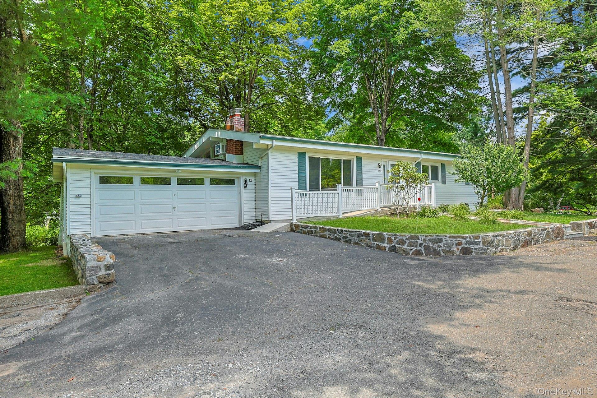 Welcome to 252 Watch Hill Road! It's the one you have been waiting for! You will fall in love with this home not just because of the style, but because it has been completely and meticulously updated! As you enter you will see the open floor plan of this beautifully updated 3-bedroom, 2-bath ranch offering stylish living and exceptional space inside and out. The open-concept main level features gleaming hardwood floors, soaring cathedral and vaulted ceilings accented with exposed beams, creating a warm and inviting atmosphere. The living room features a wood burning stone fireplace to to keep you warm on a cold winter night while the large window allows the room to be flooded with natural light during the day. The updated eat in kitchen is designed to impress with quartz countertops, stainless steel appliances, and plenty of cabinet space, making it perfect for both everyday living and entertaining. Step through the dining room to a spacious deck overlooking a private, tree-lined backyard—an ideal setting for morning coffee, outdoor dining, or relaxing in your own peaceful retreat. The completely finished lower level provides abundant additional living space, ideal for a family room, home office or extra sleeping area. The sliding glass door leads to your private yard while also filling the room with natural light as do all of the other windows in the lower level. The recessed lighting throughout the house also keeps this home light and bright! With modern updates throughout, generous living space, and a desirable ranch layout, this move-in-ready home offers the perfect combination of comfort, style, and privacy.  Located close to the schools, shopping, major highways and all that Cortlandt Manor has to offer. Don't miss seeing this exceptional gem!