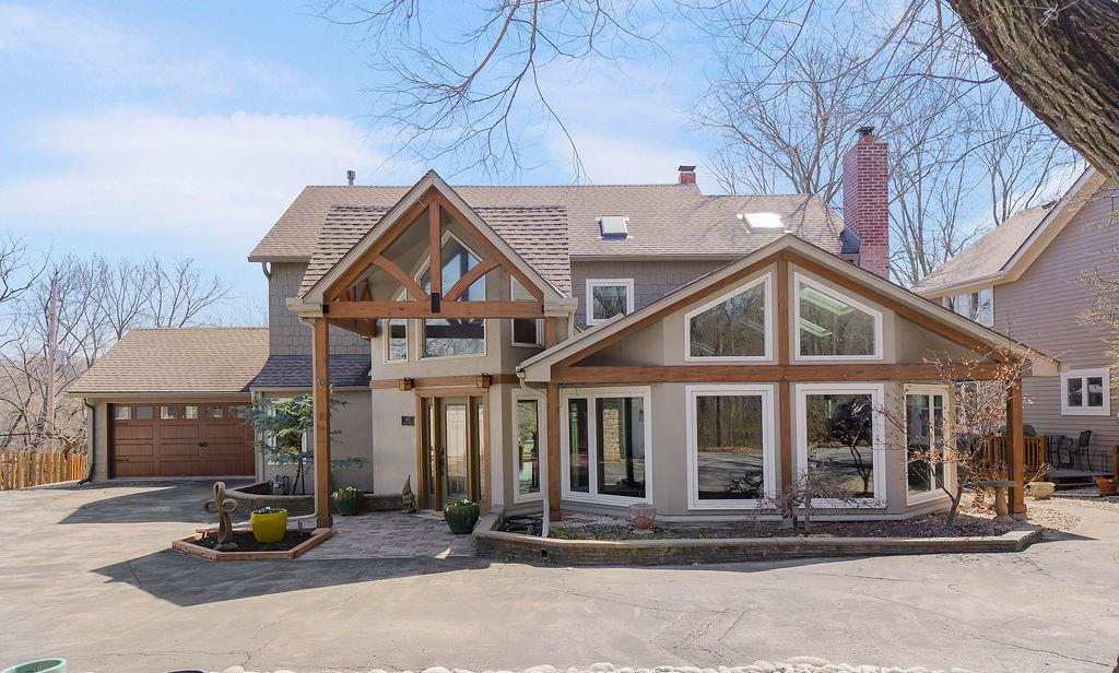 Located on a quiet cul-de-sac, this incredible home is designed for entertaining & everyday living. You are welcomed by a front entry that flows seamlessly into an exceptional great room featuring a dramatic wall of newly updated windows showcasing breathtaking lake views. The space is filled with natural light & includes a wet bar, making it perfect for hosting gatherings. The oversized dining area is ideal for large family dinners or entertaining friends. The beautifully updated kitchen is truly a chef’s dream, complete w/quartz countertops, a farmhouse sink, a warm hearth sitting area around the fireplace. If you love natural light & windows, you will fall in love with this home. Enjoy peaceful mornings on the screened porch while watching the sunrise over the lake.  The main floor also includes a guest bedroom & full bath, providing convenience & flexibility.  An open staircase leads to the impressive primary suite, where the views will absolutely take your breath away. This stunning retreat features new windows, a gas fireplace, hardwood floors, vaulted ceilings, and a private coffee bar area. An attached office or hobby room offers additional space within the suite. The primary bath includes 2 separate private vanity areas & walk-in closets, w/the shower & toilet area centrally located. The finished walkout lower level offers additional living space w/a family room, bedroom, full bath, and an unfinished storage area. Dock site #190 for all your water fun. Lake Quivira offers 24/7 professional security and an unmatched lifestyle with unlimited access to the pristine lake for boating, sailing, fishing, swimming, and hiking. Residents also enjoy a championship golf course with a state-of-the-art practice facility and golf simulator, tennis courts, indoor tennis facilities, pickleball courts, swimming pool, sauna, and horse stables. The community center and clubhouse provide wonderful gathering spaces for events and social activities. Live where you play