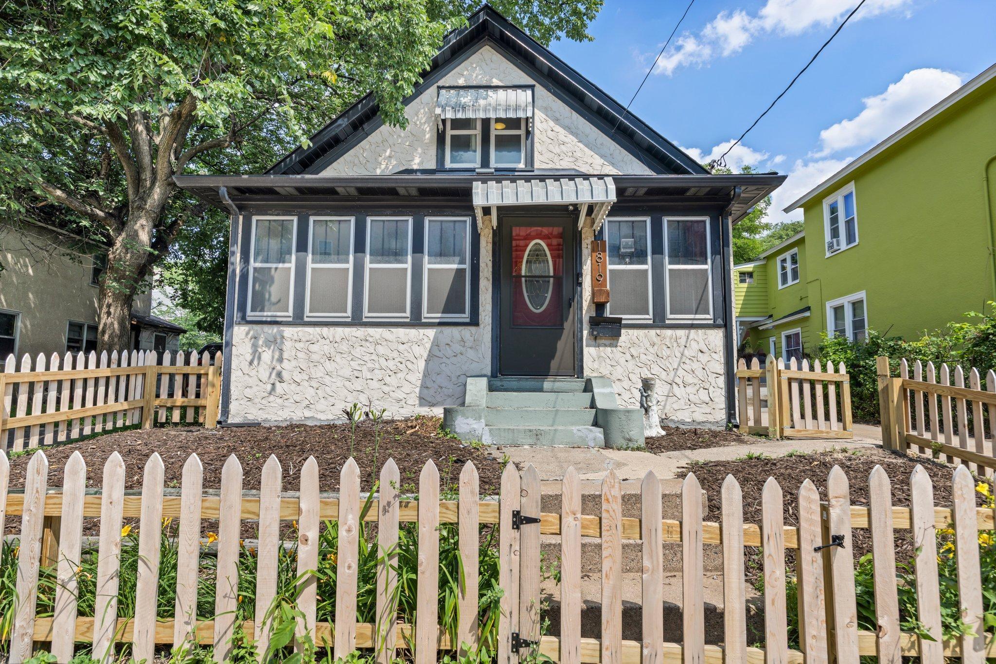 Welcome to this charming 2-bedroom, 2-bathroom home full of character, ideally located within walking distance to Boom Island Park, dining, shopping, and with easy access to downtown and major highways. The kitchen is warm and inviting, featuring original hardwood floors and charming wood trim that add character and charm. It offers ample white cabinetry for storage, a convenient double wall oven, a gas cooktop, and recently updated appliances—including a new dishwasher (2023) and microwave (2025). At the center of the space is a spacious granite island with breakfast bar seating and pendant lighting, making it a perfect spot for everyday meals or casual gatherings. The spacious main-level living room features beautiful original hardwood floors and charming arched doorways, creating a warm and inviting atmosphere. It’s the perfect place to unwind at the end of the day. Bedroom One is located at the front of the home and features a large front-facing window that fills the room with natural light. With two convenient entrances—one from the living room and another from the kitchen—this room offers flexibility and function. Original hardwood floors, built-in shelving perfect for books, storage, or décor, and a spacious closet complete the space. Just steps away is the full main-floor bathroom, updated in 2024 with new flooring and toilet, and featuring a single vanity and a tub/shower combo. Rounding out the main level is a laundry room located just off the back entrance, complete with wire shelving for added storage. Upstairs, Bedroom Two makes an ideal primary suite. It’s spacious and features wood flooring, along with a versatile attached 10x6 bonus room—perfect for a walk-in closet, cozy sitting area, or additional storage. The private en suite bathroom includes tile flooring, a classic pedestal sink, and a walk-in shower with a tile surround. The home features a spacious detached two-stall garage, ductless mini-split systems on both the main and upper levels for year-round comfort, and a fully fenced backyard for added privacy. Some recent updates include a new front storm door (2024), new roof (2023), a new kitchen window, and a new primary bedroom window (2025). Don’t miss out on the charm and character this home has to offer!