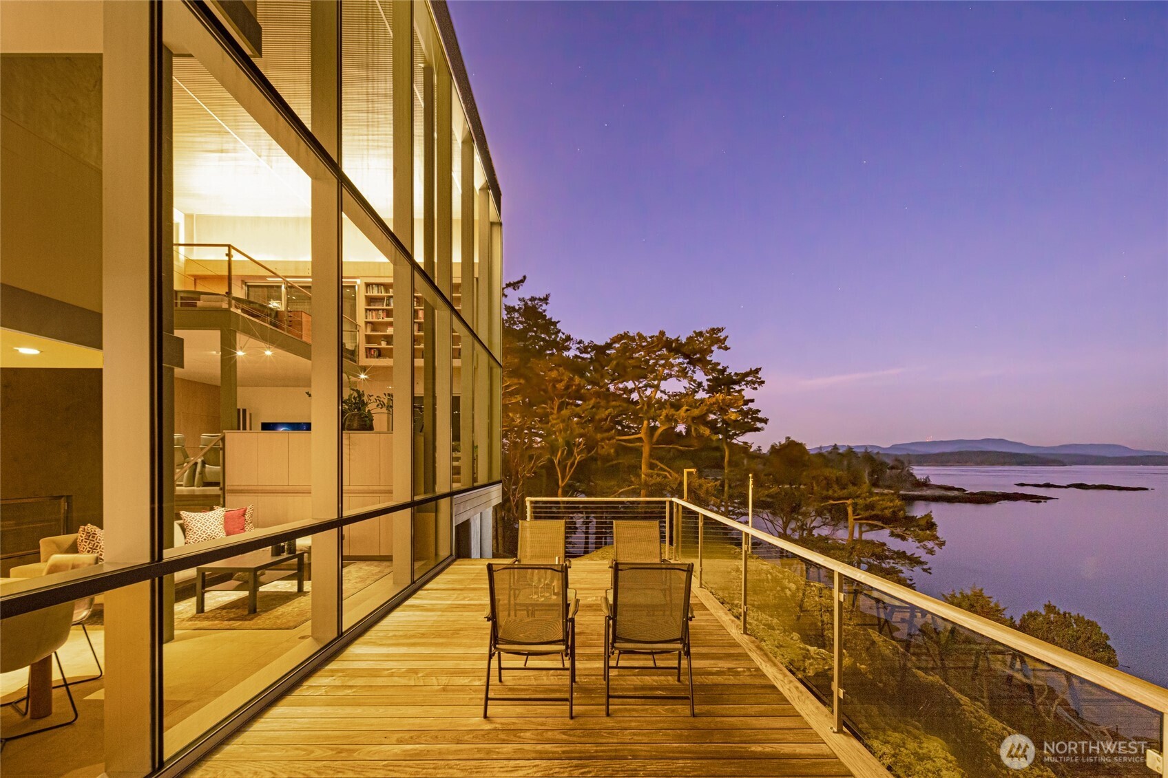 Striking contemporary waterfront retreat on Pear Point.  The property offers 2.25 acres with 166+/- feet of rocky shoreline with sweeping marine views and privacy, just minutes to town.  Exceptional views from every room and hardwood floors throughout.  Stunning glass and steel construction with a wall of windows that showcase expansive light and sunrise views of the Channel, Mt Baker, and the other islands. Designed by architect Vasso Demetrious, the home blends modern design with the natural beauty of the San Juan Islands. The multi-level main residence features 2 bedrooms and 2.25 bathrooms. The media room and stunning office both have open views and fireplaces.  The office features a built-in sliding wall bookcase. Living space, dining area and kitchen open to large decks that take advantage of views and center around a fireplace. The home features radiant heat, efficiently powered by a geothermal heating system.  Convenient state-of-the-art remote control of the lighting, entertainment and security system.  There is additional living space that provides flexibility for homeowners or guests with a game room, bedroom, bathroom, and private deck.  Access to the guest living space is via connected deck or private garage entry. Nicely finished 3-car windowed garage.  The Town of Friday Harbor has ferry and seaplane service and boat moorage, airport, shops, and other amenities.  It is a rare opportunity to own a distinctive waterfront estate in an exceptional island location.