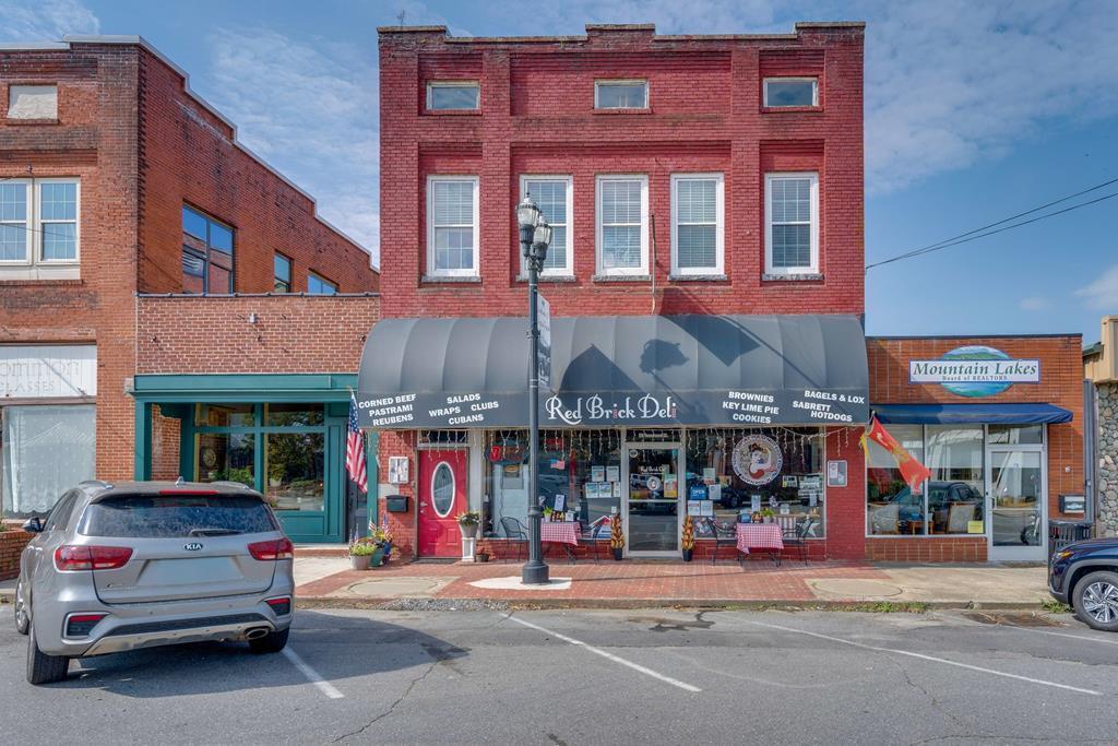 Own a Profitable Downtown Murphy, NC Restaurant + Income-Producing Luxury Loft. Step into a rare turn-key commercial investment opportunity in downtown Murphy, North Carolina, featuring the iconic Red Brick Deli, a well-established and profitable restaurant in the heart of the Western NC mountains. Located on bustling Tennessee Street, this high-visibility, walkable location is surrounded by popular boutiques, breweries, and thriving small businesses making it a prime destination for both locals and tourists exploring the Appalachian Mountains. This income-producing commercial property offers more than just a successful restaurant, it delivers a complete live/work or investment lifestyle opportunity. The Red Brick Deli is a recognized local favorite with a strong reputation, loyal customer base, and consistent foot traffic. Fully operational and equipped, this is a true turn-key restaurant business ready for immediate ownership. Above the commercial space, you'll find a stunning upscale loft-style apartment, ideal for an owner-operator, executive rental, or short-term rental/Airbnb income stream in Murphy's growing tourism market. Luxury Apartment Features Include: 10-foot ceilings and oversized windows with abundant natural light, Hardwood floors, granite countertops, and custom cabinetry, 2 bedrooms, 2 bathrooms, plus office/bonus space, Private entrance for added exclusivity and privacy.  This unique mixed-use property combines commercial income, residential luxury, and prime downtown real estate a rare find in Cherokee County. Whether you're an investor seeking multiple income streams, an entrepreneur looking for a profitable business opportunity, or a buyer wanting a mountain lifestyle with built-in income, this property checks every box. Don't miss your chance to own a landmark business and premium downtown property in Murphy, NC.
