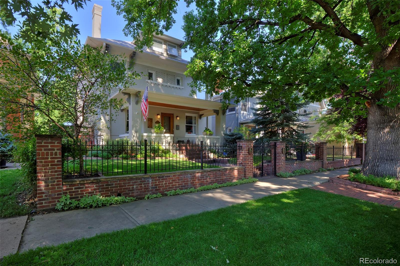 This classic Cheesman Park, 3-story, Denver Square has the perfect balance between charming historic details & high-end updates for today's living. The home has warm & welcoming finishes throughout w/ beautiful quartersawn wood trim, stained glass windows, wooden double-pane windows, functional built-ins, a grand wooden staircase & a gas fireplace in the living room adding to the cozy ambiance of the home. The kitchen has been lovingly updated w/ warm wooden cabinets, black granite countertops, undercabinet lighting & high-end appliances including a gas Wolf cooktop, built-in KitchenAid fridge & double wall-ovens. A built-in breakfast nook has bay windows overlooking the backyard & is ideal for informal meals while a formal dining room provides ample space for large dinner parties. There are 3 sizable bedrooms and 2 bathrooms on the 2nd level including a comfortable primary suite featuring a private southern facing balcony, built-in desk, spacious walk-in closet & 5-piece en-suite bathroom w/ a deep soaking tub, Euro-glass shower & heated floors. There is laundry on both the 2nd level & in the basement for convenience. The 3rd level is finished w/ hardwood flooring, 2 skylights & ample headroom providing space for a 4th upstairs bedroom or home office. The basement has plush carpet, recessed lighting, built-ins & no exposed pipes with a comfortable family room, 5th bedroom & 4th bathroom. This gorgeous wide-stance Denver Square sits proudly on a spacious lot w/ a fenced-in front yard & a beautifully landscaped backyard. An extensive deck provides outdoor living & dining space that's ideal for alfresco entertaining while a relaxing water feature, shade trellis, bistro lighting, gas firepit & hot tub make this backyard a true urban oasis. A vine covered, brick clad, 2-car garage has an oversized door and plenty of space for vehicles & gear storage. This home is ideally located just a few blocks from Cheesman Park w/ easy access to the Botanic Gardens & Cherry Creek.