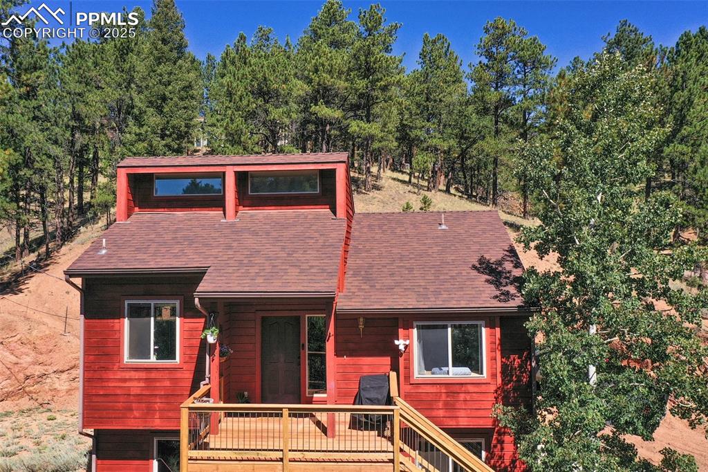Discover the perfect blend of comfort and convenience in this beautiful home, ideally located right on the outskirts of Woodland Park. This property offers easy access to community events and activities. Nestled in a picturesque community, you'll enjoy the serene beauty of a neighborhood that features a community lake, perfect for leisurely walks, picnics, or fishing. Step inside to be greeted by an abundance of natural light filling the spacious living area, and creating a warm ambiance along with the fireplace on cold days. Vaulted ceilings add to the open floor plan, making the home feel even more expansive. Butcher block countertops in the kitchen not only provide a modern touch but, also offer space for meal preparation and gathering with guests. Downstairs includes an additional bedroom, full bathroom, and family room for some indoor entertainment, or movie night. This neighborhood is also within walking distance of Charis Bible College, including a trail system to get there. Whether you're hosting gatherings with friends or enjoying quiet evenings at home, this property could be your new place to call home!