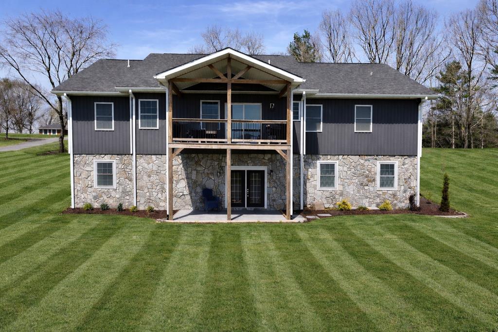 Welcome to 24 Fairway Village, an exceptional 5-bedroom, 4-bathroom home ideally positioned along the fairways of Blue Ridge Country Club. Built in 2022 and offering 3,600+ square feet of beautifully designed living space, this property combines modern comfort with stunning natural scenery, creating a lifestyle that's truly hard to beat. From the moment you arrive, you'll appreciate the home's setting in one of the most desirable neighborhoods in the area—quiet, well-kept, and perfectly tucked against the golf course. Inside, the spacious open layout is filled with natural light and framed by golf course and mountain views that make everyday living feel like a retreat. The main level features a generous living area with gas logs, an inviting kitchen with modern finishes including beautiful quartz countertops and a dining space overlooking the fairway. The spacious laundry room on the main level offers convenience and features a dog wash station to keep your companions clean with ease. Step out onto the covered deck, the perfect spot for morning coffee, grilling, or simply taking in the remarkable scenery that surrounds the home. With five large bedrooms, including a relaxing primary suite, there's plenty of room for family, guests, or flexible spaces such as an office or hobby room. The full basement adds even more potential—whether you envision a game room, home gym, media space, or additional storage. With nearly 10 foot high ceilings the potential is unlimited in this space. A convenient garage makes day-to-day living easy, and the home's newer construction means low maintenance and modern efficiency throughout. Whether you love golf, beautiful mountain backdrops, or the peaceful setting of a premier neighborhood, this home delivers it all. With direct access to the course and views you won't find anywhere else, 24 Fairway Village is a rare opportunity to enjoy luxury, space, and location in one perfect package.