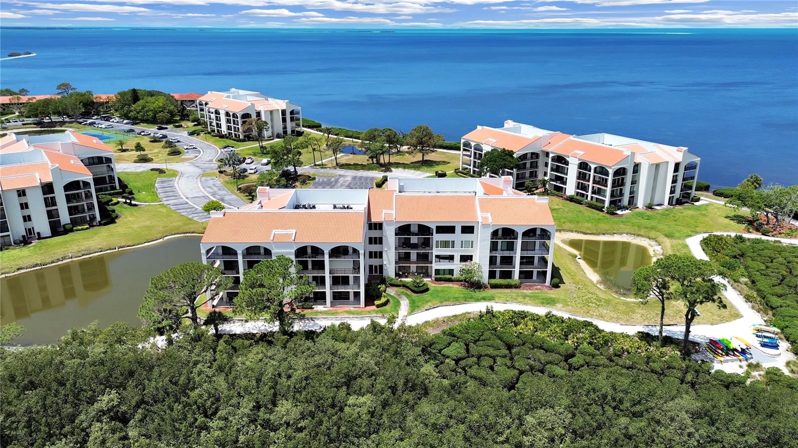 GULF WATER VIEWS!!  Sip lemonade on your private, wrap around, water view verandah; launch a kayak right at your back door & take a paddle; challenge your friends to pickleball or tennis; cool off in the sparkling pool; stroll along the waterside nature trail; host a tasty bar-b-que at the grill area; go for the "8" ball in the billiard room or just enjoy the vibrant, nightly sunsets!  Clubhouse, fitness center, sauna, library & numerous clubs & activities add to the resort style amenities.  Nestled along the Gulf of America, this gated, maintenance free, waterfront community offers sea breezes & serenity for a true Florida vibe!  Keep your boat at the community Marina - ready for a cruise!  Light & bright, this 2 bedroom/2 bath home offers tranquil water views, spacious living areas & bedrooms, numerous closets, walk in pantry & 2 large storage closets.  Use your imagination & vision to customize, personalize & make it home!  Location close to everything Tarpon Springs has to offer - art, shopping, restaurants, Sponge Docks, golf courses, beaches, parks, hospital/medical, the Pinellas Trail.  Rediscover relaxation & love where you live!  No where but here, no time but now!