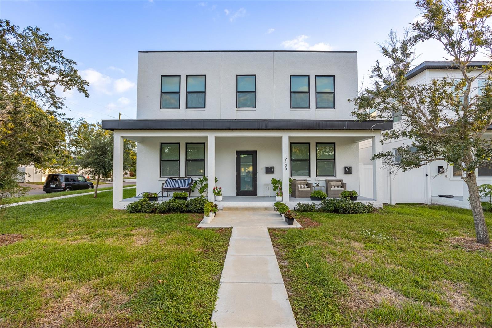 Two homes, one exceptional St. Petersburg property! Situated on a corner lot, 5100 3rd Avenue North features a 3-bedroom, 2.5-bath main home plus a separate 2-bedroom, 2-bath guest house in the rear—offering flexibility for visiting guests, multigenerational living, or potential rental income. The main home welcomes you with an open layout connecting the living, dining, and kitchen areas. Quartz countertops, white shaker cabinetry, stainless steel appliances, and a breakfast bar create a stylish and functional kitchen, while luxury vinyl plank flooring provides a cohesive look throughout. Upstairs, the primary suite features a double vanity and glass-enclosed shower. The separate guest house adds two bedrooms and two full bathrooms, providing private accommodations apart from the main residence. With a combined five bedrooms, four full bathrooms, and one half bath, this property offers space and versatility in a convenient location near Tyrone shopping, dining, downtown St. Petersburg, and the Gulf beaches. Schedule your private showing today!