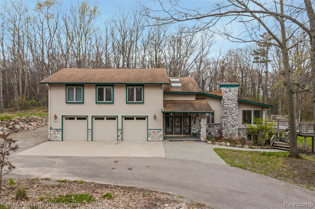 The winding driveway feels like your own private country road and leads to a welcoming paver stone porch and path. The foyer features two skylights that fill the space with natural light. The heart of the home is the open concept kitchen, dining, and living room, all connected by beautiful diagonal wood floors. The updated kitchen offers dark countertops, shaker style cabinets, stainless steel appliances, and exceptional cooking space. Thoughtful features include an extra deep sink with custom accessories and pantry space with convenient roll outs. The expansive counters are ideal for both baking and entertaining. The attached dining area continues the bright and modern feel.The living room features an inviting wood burning stove that creates a cozy atmosphere for winter evenings. The main floor laundry room includes a built in dog door plus an interior door for easy separation. The spacious primary suite offers two walk in closets and a private bath with double sinks and a luxurious walk in shower with dual shower heads. All upstairs bedrooms provide generous closet space. A second floor media room is perfect for homework, gaming, or additional living space.The finished walkout basement includes a kitchenette, full bathroom, and fourth bedroom, making it ideal for multi generational living or guest space. The three car garage features insulated doors with three openers and provides access to the home and workshop. A separate flexible space is perfect for a project space, studio, gym, or hobby room.Outdoor amenities include multiple areas to relax and enjoy nature along with a wood shed, shed with chicken coop, and a 20x30 pole barn. With 20 private acres to enjoy, the possibilities are endless.All this and even a whole house generator!This sale also includes parcel number 0508400004.