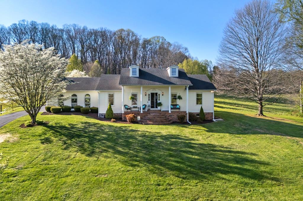 Tucked away along a scenic country road in the foothills of Southwest Virginia, this enchanting property offers the perfect blend of privacy, charm, and refined outdoor living on 1.74 beautiful acres. Set against the backdrop of Clinch Mountain, this thoughtfully designed one-level home features 1,942 sq. ft., 3 bedrooms, & 2 fully updated baths. From the inviting front porch with graceful semi-circle brick steps to the warm, welcoming interior, every detail has been carefully curated.  Inside, you'll find gleaming hardwood floors throughout, complemented by tile in both baths and new luxury vinyl plank flooring in the bedrooms. The home has been freshly painted in warm, earthy tones, enhanced by updated lighting and fixtures for a clean, modern feel. The kitchen is both well organized & updated, featuring granite countertops, a stylish glass tile backsplash, stainless steel appliances (all conveying), two food pantries, and a center island perfect for casual dining.  Open to the kitchen, you'll enjoy a spacious dining area overlooking the pool setting creating a seamless connection to the outdoor living space.  The 550 sq. ft. den offers a cozy yet impressive gathering space with a striking wall of brick fireplace, vented gas logs, & custom arched built-in bookcases, while palladium windows fill the room with natural light.  Step outside to experience what truly sets this property apart An 18x36 in-ground pool with an 8 ft. deep end, expansive patio, & a custom outdoor kitchen that creates a private backyard retreat ideal for entertaining or relaxing. The pool setting is beautifully framed by estate-style brick columns with elegant black metal fencing and classic orb finials, adding a touch of timeless sophistication. Adding both charm & convenience is a unique rotunda-style pool room, offering a private bath and dedicated pool equipment room—perfect for guests and effortless poolside living without ever needing to step inside.  Move-In Ready & Immaculate-cont.