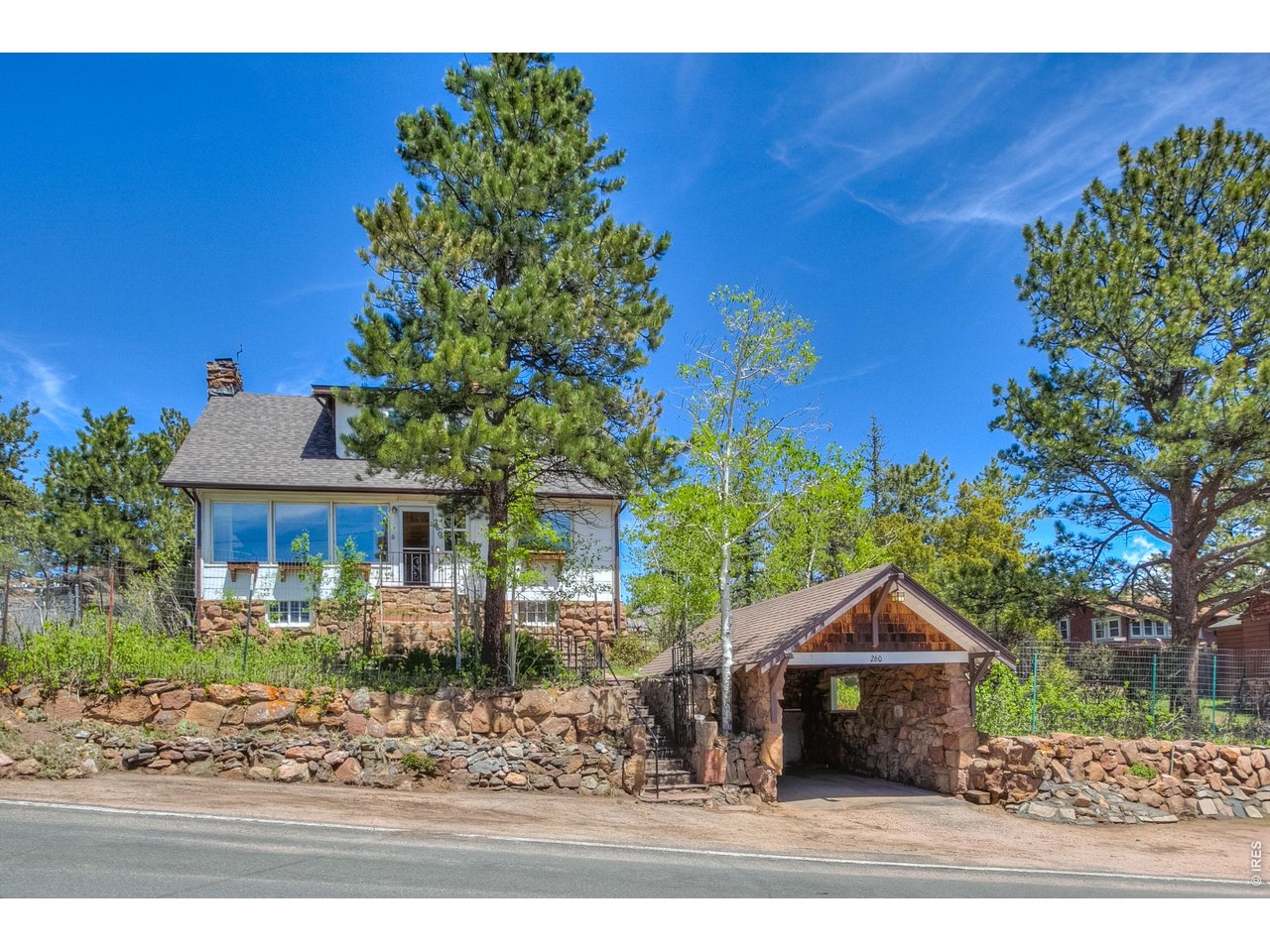 Rare opportunity with an extra vacant lot included, offering endless possibilities. The attached vacant lot at 331 Virginia Dr is approximately .22 acres and is also zoned RM (Residential Multifamily), creating potential for a duplex, second or multiple homes, investment property, or expanded mountain retreat. Think of the possibilities! Ideally located within walking distance to downtown Estes Park, this unique property features incredible views of Longs Peak, Lake Estes. The home has been updated over the years, plus well maintained and offers convenient main level living, a spacious living room, and an upper level with primary bedroom with wash area, walk in closet, bonus amazing views and one guest bedroom, shared full bath. Tons of storage throughout. Recent improvements include a new roof, plus a one-of-a-kind garage built into the rock hillside. A must-see property for the style, setting, views, and future potential.