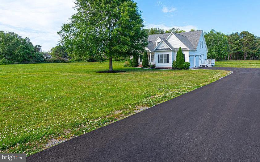 LOCATION, LOCATION, LOCATION! This beautiful home is ideally situated between Berlin and Ocean City on 2.5 acres of cleared land, offering endless possibilities—add an inground pool, pole barn, or create the perfect setup for a home-based business. No city taxes and NO HOA fees.Built by Beracah Homes, this property features an excellent floor plan and has undergone extensive updates in 2025–2026. The fully renovated kitchen showcases new cabinetry and hardware, granite countertops, tile backsplash, and energy-efficient stainless steel appliances. Bathrooms have been updated with new vanities, faucets, mirrors, and light fixtures. The first floor boasts all new lighting and brand-new LVP flooring throughout.The main level includes a primary suite with private en-suite bath, a second bedroom and full bath, a separate dining room, a spacious living room with a wood-burning fireplace, a half bath, and a rear screened-in porch under roof—perfect for relaxing year-round. Upstairs you’ll find a loft/landing area ideal for a workspace, two oversized bedrooms, an office, and another full bath featuring a new double vanity, mirrors, and fixtures.Recent improvements also include the septic system just pumped, drain field rooted, and a new distribution box installed and a brand  new blacktop driveway There are no other properties currently available offering this amount of cleared land this close to Rt 50 in the Berlin Ocean City area, making this a rare opportunity.  Plenty of room for a pole barn and in ground swimming pool! Located just one mile from Stephen Decatur schools and minutes from Ocean Pines, Ocean City, Assateague Island, and Historic Berlin, with Salisbury Airport only 20 minutes away. If you’re seeking space, convenience, and freedom from fees and city taxes—this is the one. Some photos do not reflect the new blacktop driveway