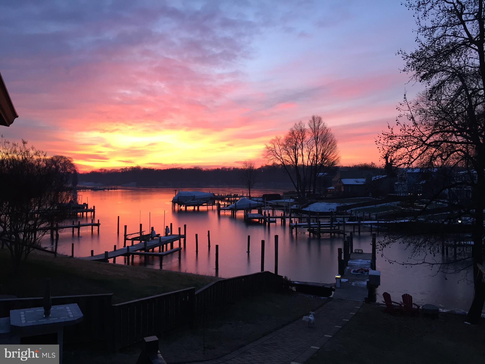 GORGEOUS 3 Bedroom 2 FULL and 2 HALF Bath WATERFRONT Home on Sue Creek *  Open foyer * Wood burning fireplace in the living room * Wet bar * Hardwood floors on MAIN level * Kitchen with GRANITE countertops, breakfast bar and subzero fridge * BEAUTIFUL Sunroom off kitchen with covered deck OVERLOOKING the water * LARGE rec room in lower level * Pier with 100 amp service to the tower and 50 amp outlet * Attached shed * 2 car attached garage with a 5 PLUS car driveway *Hardscape walkway to Pier * Roof (2018) * Hot water heater (2023) *  Private boat launch ramp and pier for the HOA that has a keycard for 24/7 access * This Fabulous waterfront property has been well maintained and offers mature landscaping * Navigate from Sue Creek to Hart Miller Island for SUMMER boating fun and Holiday parades!!