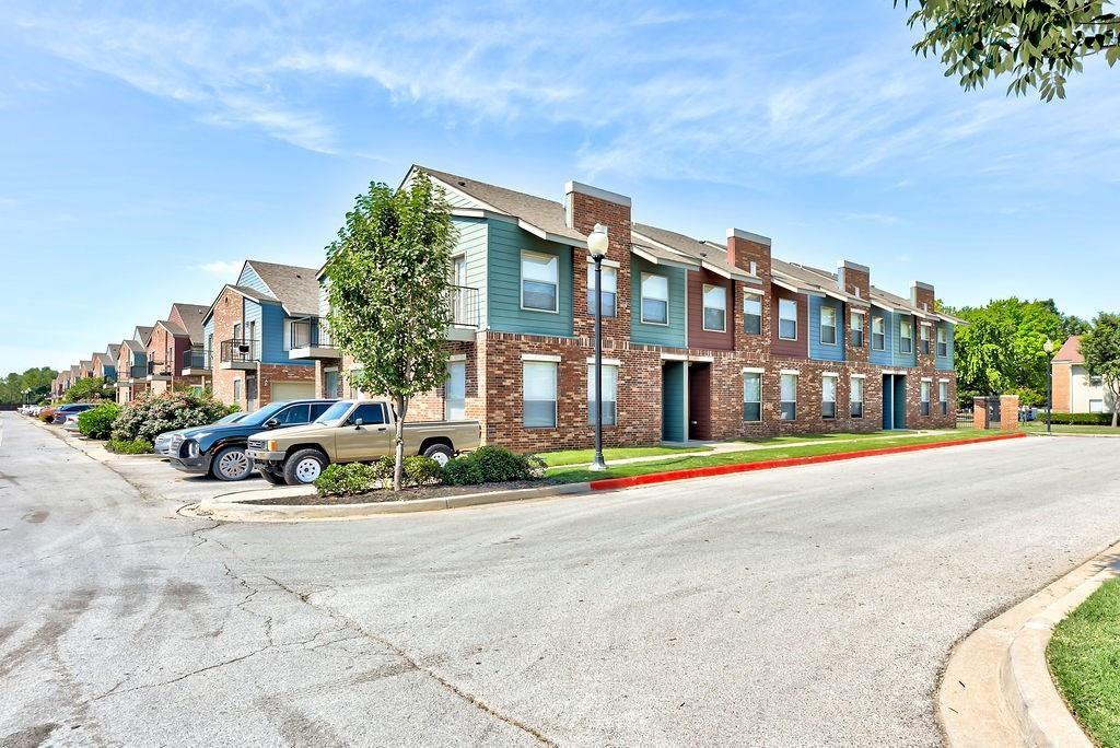 MOTIVATED SELLER! Are you looking for a Townhouse that is a short walk to campus and the OU football stadium? The location of this unit is ideal! The ground floor has 2 bedrooms, a full bathroom, and a oversized 2 car garage. Up the stairs you find an open concept living space. The open living room and kitchen make the most of your square footage. The kitchen, with its functional u-shaped layout, has stained wood cabinetry, tile work, convenient breakfast bar, and durable granite countertops. Also upstairs is the primary bedroom/bathroom suite, complete with double sinks and a walk-in closet. In addition there is an in-unit laundry space and a balcony patio making this home amazing. NEW HVAC SYSTEM 09/2024!