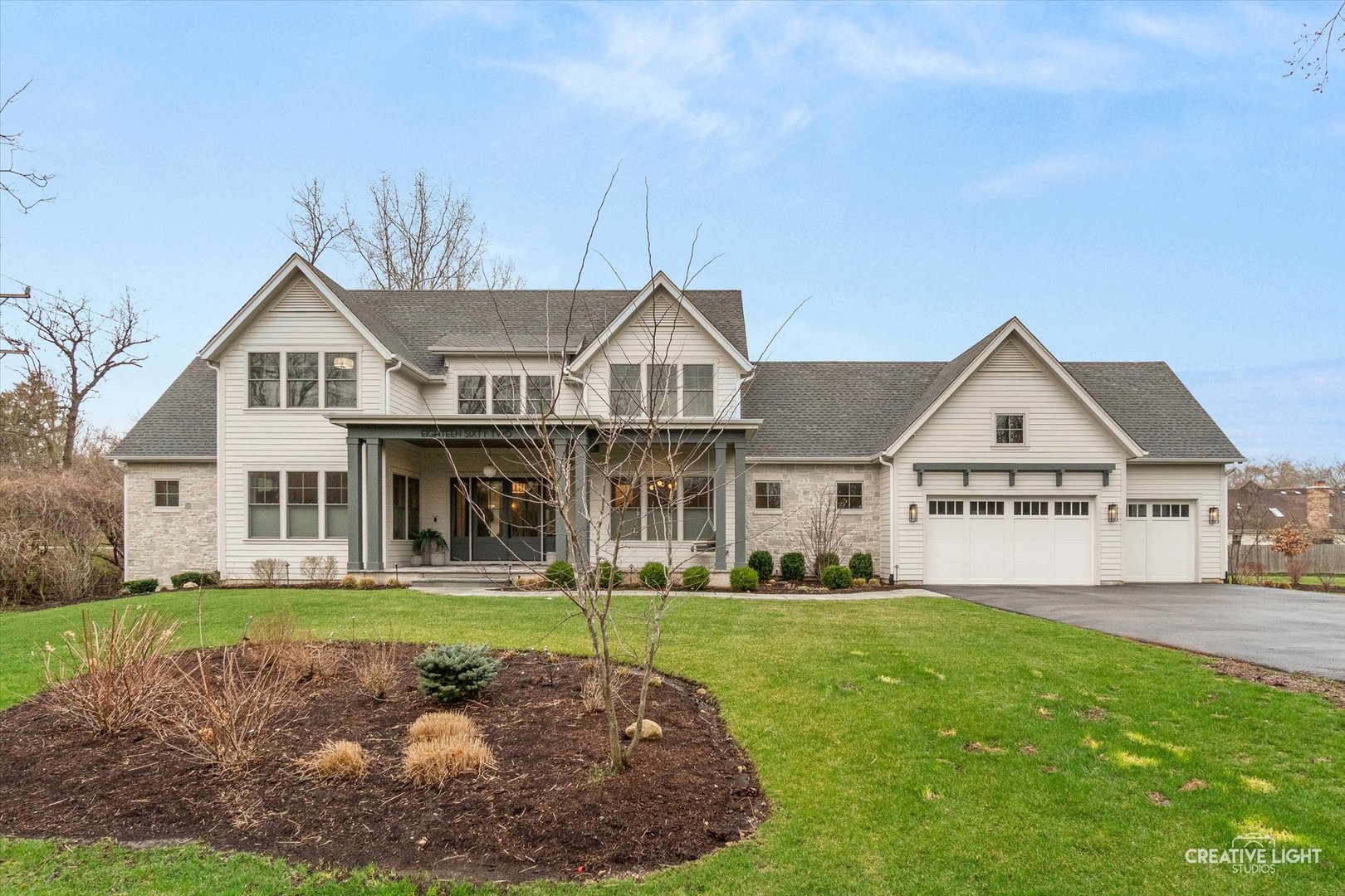 This exceptional custom home, built by renowned Naperville builder M House Development, offers a rare blend of refined design, elevated finishes, and an unbeatable location. From the moment you arrive and step onto the covered front porch, the craftsmanship and thoughtful detail are immediately apparent. The foyer opens to a breathtaking great room where soaring two-story ceilings, a statement fireplace, custom built-ins, plumbed for an elevator, and motorized blinds create a space that is both dramatic and inviting, all bathed in natural light. Rich hardwood flooring carries you into the heart of the home-a stunning chef's kitchen designed for both beauty and function. A striking quartz island anchors the space, complemented by custom cabinetry featuring specialized storage for every need, from utensils and spices to cookware and baking essentials. Elegant blue tile accents provide a sophisticated backdrop to the Cafe stainless steel appliances. The adjacent breakfast room is a showpiece of its own, surrounded by windows on three sides and highlighted by a beautifully detailed wood ceiling, while a spacious walk-in pantry ensures everything has its place. The main level primary suite is a true retreat, showcasing a designer ceiling with wood beams, a custom walk-in closet, and a spa-inspired bath complete with dual vanities, a tiled shower with seating, heated tile floors, and a private water closet with a smart toilet with bidet. This level also offers a second bedroom, a versatile den, a formal dining room, a full bath, and an exceptionally well-designed utility room with abundant storage for everyday living. The four-season room is not to be missed, featuring a wood ceiling and heated bluestone floors, creating a cozy yet sophisticated space to enjoy year-round. Upstairs, a spacious loft overlooks the great room and is flanked by two generously sized bedrooms. The thoughtfully designed full bath includes a beautifully tiled tub and shower area that can be separated by a pocket door, allowing for added convenience and privacy. The basement continues to impress, offering direct access to the garage, a completed full bath, and endless possibilities for additional living or entertaining space. The oversized three-car garage is equipped with an electric vehicle charging outlet, while the home's advanced mechanical systems-including dual zoned HVAC with humidifiers, two 200-amp panels, multiple water heaters including one dedicated to radiant heat, a passive radon system, and a whole-house generator-ensure comfort, efficiency, and peace of mind. Set on nearly 1.3 picturesque acres with a natural wetland and direct adjacency to the Prairie Path, the outdoor setting is as remarkable as the interior. A slate patio and covered back porch with gas grill, create the perfect backdrop for entertaining or relaxing in a serene environment. All of this is complemented by highly acclaimed District 200 schools, along with convenient access to shopping, dining, and nearby forest preserves, making this home a truly extraordinary offering.