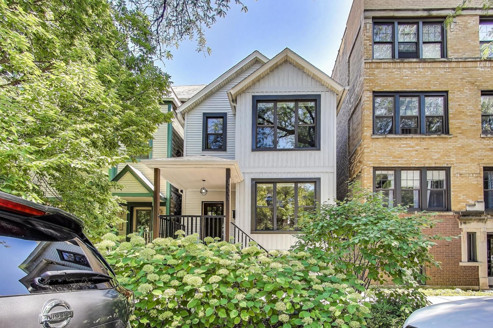 Lakeview - Prime location. This beautifully renovated single-family home on a full-size lot (25x125) with a 2-car garage offers a spacious, modern living environment with custom details and high-end finishes throughout. Thoughtfully redesigned, the home blends functionality with stylish design, ideal for both family living and work-from-home needs.  Featuring 4 bedrooms plus a dedicated office, a separate custom loft with skylights, 3 full baths, and a first-floor powder room, this residence offers incredible versatility. Sunlight floods the open-concept main level, where you'll find a welcoming entry, spacious living room with a stunning gas-ventless stone fireplace, and gleaming wood floors.  The Chef's kitchen is a showpiece, boasting stainless steel appliances, 42" white cabinetry, exquisite quartzite countertops, and a waterfall breakfast bar with seating for four.  Upstairs, three generously sized bedrooms, a unique loft, and a bright, dedicated office with walls of windows provide abundant living options. An oversized laundry closet with full-size washer/dryer and two full baths completes this level. The primary suite impresses with vaulted ceilings, oversized windows, skylights, custom lighting, and a spa-inspired bath with gorgeous stonework, double vanities, and an oversized glass shower with dual shower heads.  The lower level is built for entertaining, complete with a wet bar, beverage refrigerator, and projector with motorized screen - perfect for movie nights or game days. An additional bedroom, full bath, and ample storage complete the space.  Outdoor living shines with a designer terrace featuring composite decking, stylish furnishings, outdoor draperies, and a mounted television with chandelier. The rear yard with artificial turf is ideal for both play and pets.  Additional highlights include:  Custom closets throughout, Dual-zoned heating and cooling with dampers, 2-car garage with electric car charger, Flood-prevention upgrades (sump pump, ejector pump, drain tiles)  All of this in a prime Lakeview location, close to the CTA at Wellington and Belmont, shopping, dining, Southport Corridor, Wiggly Field Dog Park, Hamlin Park, and top-rated schools.  This stunning home shows like a model and is in impeccable condition - truly move-in ready.