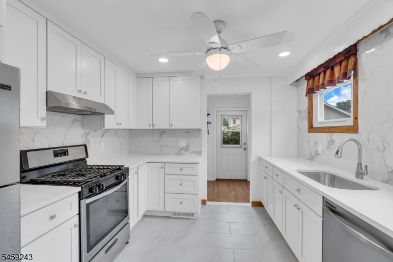 Affordable living in one of New Jersey's most desirable communities.This move-in-ready Cranford home blends classic charm with modern updates. The renovated kitchen features granite countertops, tile backsplash, LED lighting, stainless steel appliances, and a walk-out pantry. French doors open to bright living and dining rooms with new luxury vinyl plank flooring.  Upstairs offers three spacious bedrooms, all-new flooring, ample closet space, a full bath, and a versatile bonus den ideal for a home office, playroom, or reading nook. Outside, enjoy a large deck overlooking your private backyard, plus a large driveway and additional street parking.  Located in historic Cranford, close to award-winning downtown shopping, restaurants, parks, highly regarded schools, major highways, and public transportation. An excellent opportunity to own a great home in one of New Jersey?s most desirable communities!
