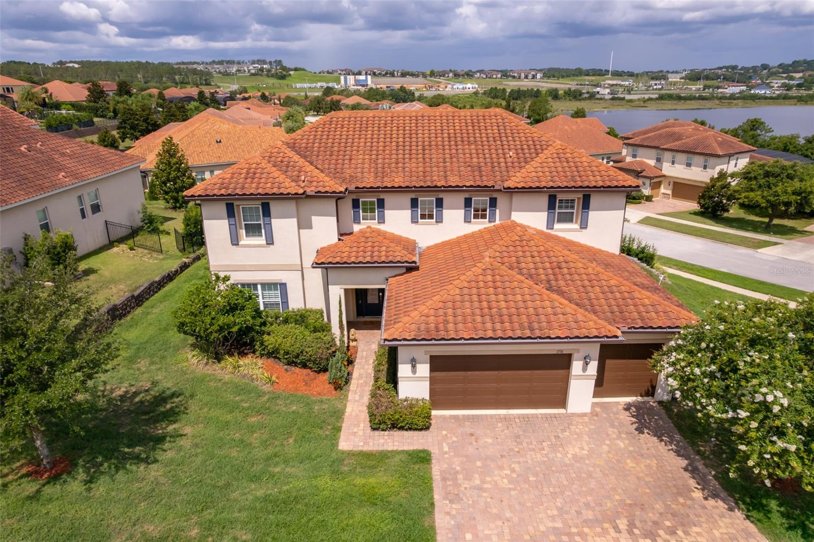 Experience refined living in the exclusive gated community and enjoy the peaceful atmosphere of Bella Lago with the tranquil presence of Lake Felter just steps away. This custom-built residence offers nearly 3,640 sq. ft. of impeccably crafted living space set on a premium corner lot, combining elegance, functionality.Designed for both elevated everyday living and effortless entertaining, the home features 5 bedrooms and 3 bathrooms, each thoughtfully arranged for comfort and privacy. The grand foyer opens to soaring 20-ft ceilings and expansive windows that flood the interior with natural light, creating a warm, inviting atmosphere.The newly renovated chef’s kitchen features a 5 ft x 10 ft island, granite countertops, gas cooktop, double wall ovens, new stove and microwave, walk-in pantry, and modern cabinetry. The first floor includes plantation shutters, an electric fireplace, tile flooring in common areas, wood-style flooring in the living room, and carpeted bedrooms.Upstairs, the spacious primary suite offers large walk-in closets. Outdoors, the home includes a custom retaining wall, enhanced front landscaping, and a backyard ready for a pool, garden, or future outdoor living space.Close to major highways, schools, shopping, and attractions, this home delivers luxury, space, and convenience within an exclusive gated community.