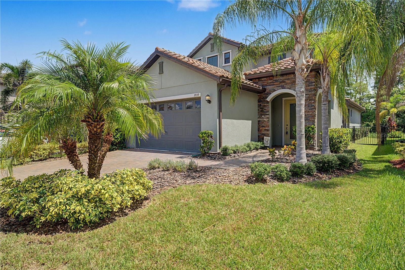 Welcome to this beautifully upgraded 3-bedroom, 2.5-bath home with a den/office, first-floor primary suite, and peaceful conservation views in the desirable Arbors at Waterside community of Lutz, Florida. Offering an impressive combination of modern finishes, flexible living space, privacy, low HOA fees, and NO CDD fees, this move-in-ready home is designed for comfortable Florida living and entertaining.Step inside to a grand, light-filled entrance featuring soaring ceilings, elegant tray ceiling details, and an open-concept floor plan. The gourmet kitchen is the centerpiece of the home, featuring quartz countertops, stainless steel appliances, a gas cooktop, built-in oven and microwave, deep farmhouse sink, subway tile backsplash, breakfast bar, abundant cabinetry, and generous counter space. The kitchen flows seamlessly into the spacious dining and gathering areas, where triple sliding glass doors showcase tranquil conservation views and fill the home with natural light.Open the sliders to the screened lanai and enjoy your own private outdoor retreat overlooking the conservation area with no immediate rear neighbors—perfect for morning coffee, relaxing evenings, or entertaining family and friends.The spacious first-floor primary suite offers privacy and convenience with a large walk-in closet and beautifully appointed en-suite bathroom featuring dual quartz vanities and an oversized walk-in shower. Also located on the first floor is a dedicated den/office or flex space, guest half bath, under-stair storage, and a custom drop zone at the garage entrance complete with cabinetry and quartz countertops.Upstairs, the wood-spindle staircase leads to two additional bedrooms and a full bathroom featuring a double vanity and a separate shower and commode area, creating a functional layout for family members or overnight guests.Additional upgrades include quartz countertops throughout, a stone-accented exterior elevation, paver driveway with fresh sealant, epoxy-coated garage floor, screened lanai, conservation homesite, and custom built-in drop zone.Enjoy low HOA fees and NO CDD fees along with neighborhood amenities including a community lake and park. Ideally located in Lutz with convenient access to US-41, SR-54, and the Veterans Expressway (SR-589), this home puts shopping, dining, grocery stores, medical facilities, recreation, nature parks, trails, and the greater Tampa Bay area within easy reach.If you're searching for a move-in-ready Lutz home with a first-floor primary suite, dedicated home office, gourmet kitchen, conservation views, screened outdoor living, and no CDD fees, this one deserves to be at the top of your list. Schedule your private showing today!