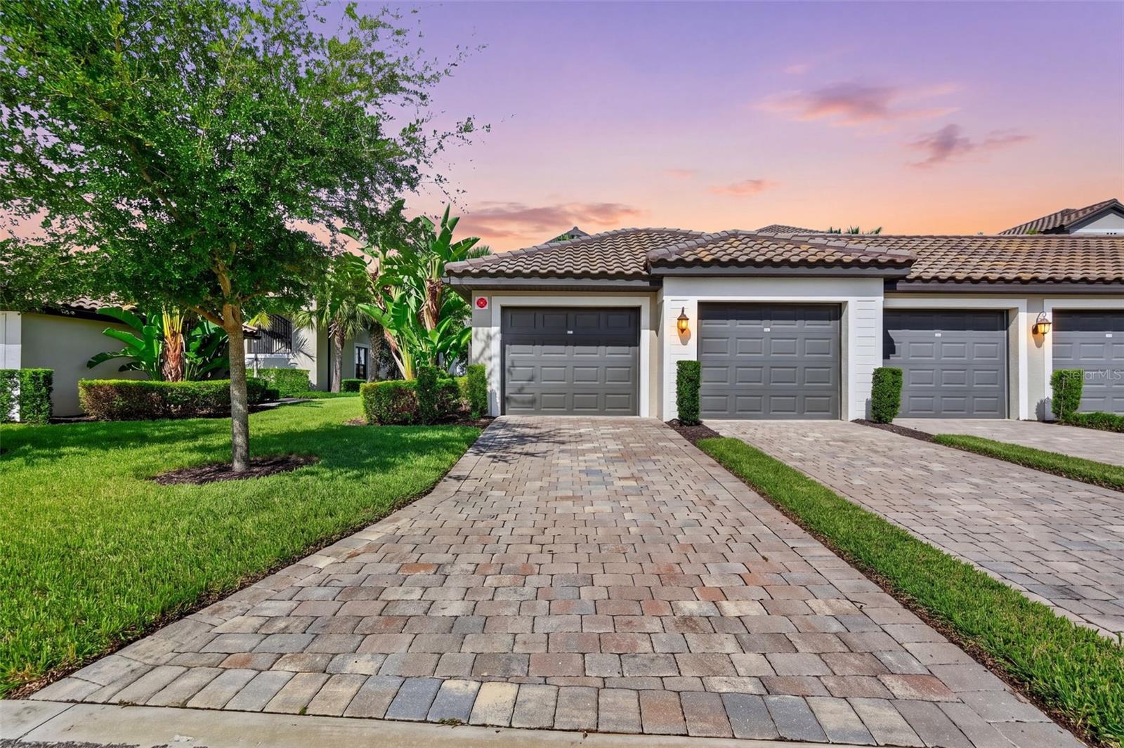 Under contract-accepting backup offers. Welcome to 5674 Palmer Circle #101, a TURNKEY FURNISHED Arabella veranda condo offering golf course views and an exceptional location within the gated, bundled-golf community of Lakewood National Golf Club. This desirable END-UNIT residence features 2 bedrooms, 2 bathrooms, a den and a detached 1-car garage, with the added benefit of an extra window in the den that brings in additional natural light. The open-concept layout is designed for both everyday living and entertaining, with the kitchen flowing seamlessly into the dining and living areas. Step outside to the screened lanai and enjoy the beautiful golf course setting—an ideal spot for morning coffee, evening cocktails or simply relaxing and taking in the Florida lifestyle. A second screened lanai at the front of the residence provides another inviting outdoor living space. Offered turnkey furnished, this home makes it easy to begin enjoying Lakewood National from day one.Lakewood National is one of Lakewood Ranch's premier bundled-golf communities, featuring 36 holes of Arnold Palmer-designed championship golf on the Commander and Piper courses. Beyond golf, residents enjoy an impressive resort-style amenity package including a grand clubhouse with dining and bar, a resort-style lagoon pool, poolside dining, a 24-hour fitness center, full-service spa, eight lighted Har-Tru tennis courts, pickleball and bocce. The community is gated with 24-hour security and offers an active social and recreational lifestyle. Whether you're searching for a full-time residence, seasonal retreat or an opportunity to enjoy the bundled-golf lifestyle, this turnkey furnished Arabella combines a desirable end-unit design, golf course views and outstanding amenities in the heart of Lakewood Ranch.
