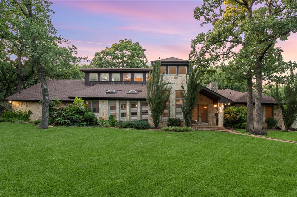 Experience luxury living on 5 serene, tree-lined acres in the coveted Woodlands Addition of Mansfield. This architecturally striking home offers over 4,200 square feet of refined living space all on one level featuring 4 spacious bedrooms - each with its own ensuite bath - providing ultimate privacy and comfort. The beautifully updated kitchen boasts granite counters, an expansive island, custom cabinetry and seamless flow into multiple living and dining areas, all flooded with natural light.
Retreat to the oversized primary suite complete with a cozy fireplace, custom closet system and spa-like bath with dual vanities, soaking tub and walk-in shower. Entertain with ease in the dedicated media room or step outside to your private backyard oasis featuring a sparkling pool, spa and covered patio surrounded by mature trees.
Equestrian lovers will appreciate the 4-stall barn and cross-fenced grounds, while a peaceful pond adds to the estate-like setting. Additional amenities include multiple fireplaces, built-ins throughout, a library, loft, 3 HVAC units only 5 years old, 3 water heaters, 4 year old roof, gated entry, circular driveway and 2 garages that can house up to 5 cars with oversized bays.
This rare, no-HOA property combines quiet country charm and a convenient location to shopping, dining and major highways. A truly special retreat that must be seen to be fully appreciated.