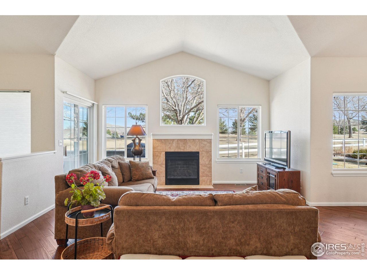Welcome home to effortless Colorado living. Nestled in the sought-after Fairway Ridge at Mariana Butte community, this pristine patio home backs to the Mariana Butte Golf Course with sweeping foothill views that make every season feel like a retreat. Whether sipping morning coffee on the private deck, curling up by the gas fireplace on a crisp evening, or simply taking in the scenery through the main level's expansive windows, this home delivers the serene backdrop you've been searching for. Inside, the open floor plan flows beautifully - wood floors, vaulted ceilings, arched doorways, and an abundance of natural light give the home an airy, welcoming feel. The kitchen is as functional as it is charming, with ample counter space, plenty of storage, glass-front cabinetry with a built-in wine rack, bar top seating, and all appliances included. The main-level primary suite is a true sanctuary with high ceilings, a ceiling fan, a spacious walk-in closet, and a spa-like 5-piece bath with double sinks, soaking tub, walk-in shower, and separate water closet. Also on the main level, you'll find a versatile office with wood floors and bay windows, a convenient half bath, and a laundry room with included washer and dryer and cabinet storage. Everything you need, all on one level. The finished basement expands your living options considerably. A large family room with recessed lighting and deep egress windows offers flexible space for a recreation room, hobby area, or comfortable guest suite - complete with a spacious closet that makes it an easy third bedroom. A well-appointed second bedroom with its own walk-in closet and a three-quarter bath with a large walk-in shower rounds out the lower level, giving guests or family members a comfortable, private space to call their own. The HOA handles landscaping, snow removal, and exterior maintenance - leaving you free to travel, explore, or simply enjoy the home without the upkeep. This is the lock-and-leave lifestyle done right.