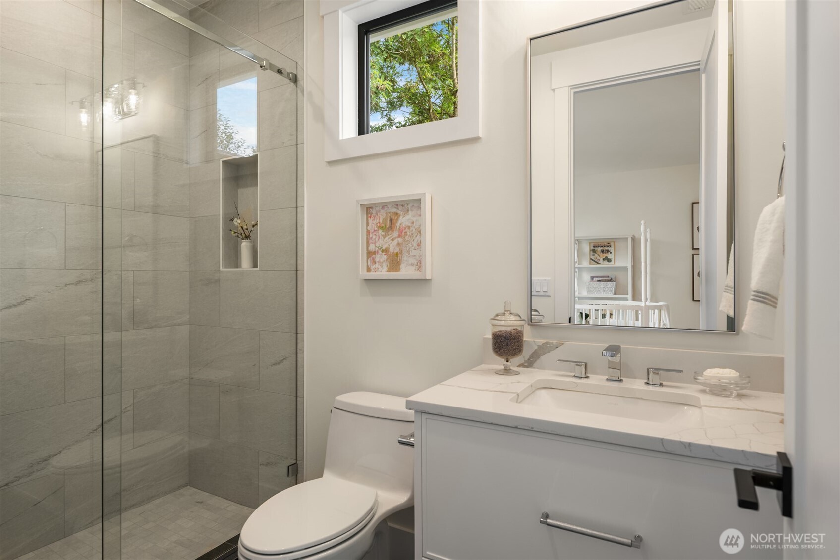 Modern bath with a glass-enclosed shower.