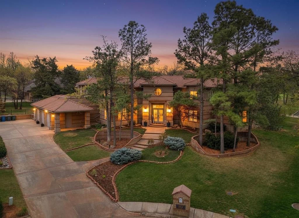 Luxury estate on the 12th tee of Oak Tree West offering a true year-round, resort-style retreat. The backyard is built for both relaxation and entertaining, featuring a stunning pool with cascading waterfalls and fountains, multiple outdoor living areas, and lush, tree-filled landscaping that creates total privacy.Inside, you’ll find several spacious living areas designed to host and gather with ease. The main living room impresses with soaring ceilings that enhance the home’s open, airy feel. The fully remodeled kitchen is a standout, complete with double ovens, a built-in refrigerator, and a large island, plus a convenient beverage station just off the main space.The primary suite is located downstairs and features a beautifully remodeled spa-style bathroom with heated floors. Secondary bedrooms are upstairs, offering separation and flexibility. This home is a show stopper!