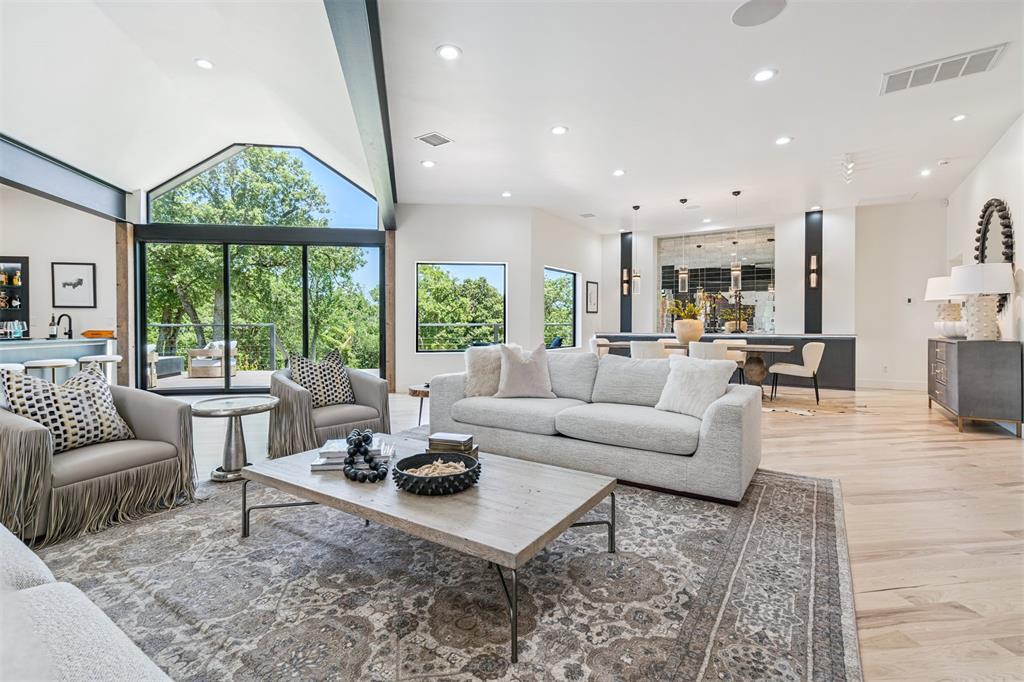 A secluded Scandinavian sanctuary with unparalleled privacy and  unique architectural beauty.  Nestled within a heavily wooded rolling acreage with approx. 30 unplatted acres. This secluded  retreat, accessed via a private gate, offers the rare combination of complete tranquility and convenient access to the city.  The original land run homestead has been transformed into an eclectic masterpiece, seamlessly blending history with modern design.  Hand-hewn wood beams and industrial steel supports create a striking aesthetic, accentuated by expansive glass insets in large frame windows and double front doors that invite abundant natural light.  Skylights further illuminate the sophisticated interiors. Throughout the home, original stone structures from statehood lend a timeless charm and a sense of deep-rooted history.  The elaborate residence boasts 5 bedrooms, ensuring ultimate comfort and privacy for all.  Entertainment possibilities are endless with a grand theatre room, a golf simulator room with adjacent game room.  The kitchen is a culinary dream, featuring an expansive banquette attached to a stunning waterfall-edged island and a gourmet appliance package, including a built-in  espresso machine.  Designed for grand scale entertaining, the kitchen flows effortlessly into two dining spaces, a spacious living room, a wet bar, and a dining  room with a sleek built-in buffet.  Step outside to your private oasis, where a spa-like pool with waterfall and fire bowls creates a captivating ambiance.  Enjoy the dedicated outdoor living area, a full outdoor kitchen, and an 8-pin putting green, all set against the backdrop of your private, wooded surroundings.  This truly unique property offers an escape from the ordinary, a private haven just moments from urban conveniences.