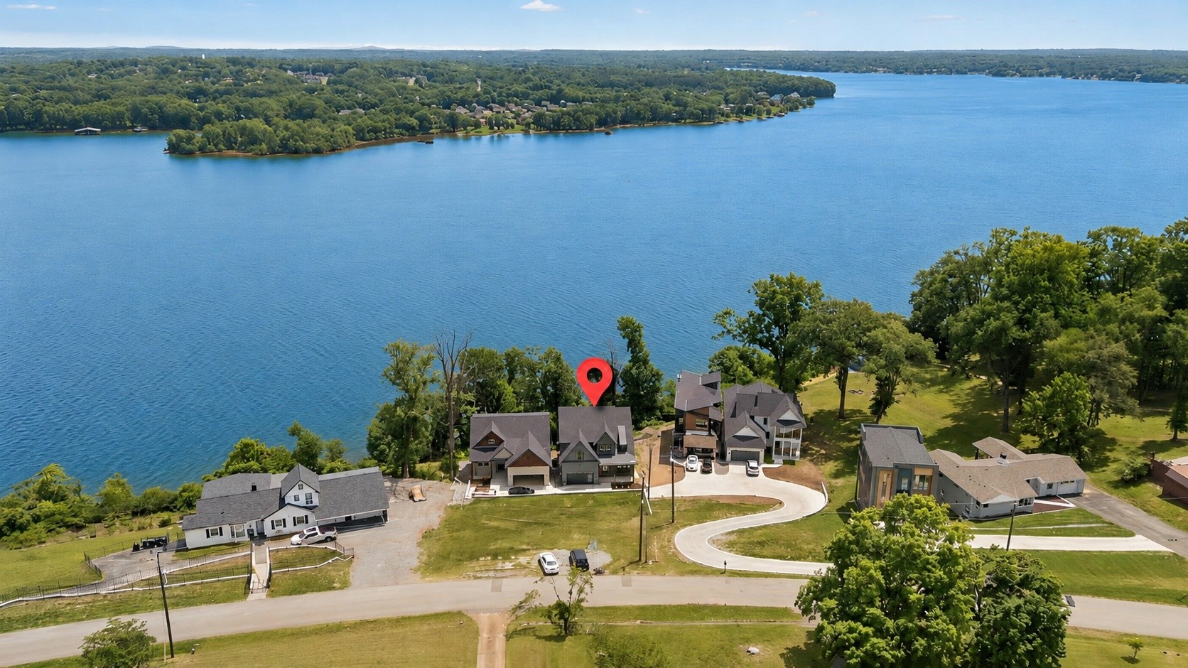 Welcome to life on Old Hickory Lake, where panoramic water views, exceptional living spaces, and a private dock planned just steps from your door create the effortless lake lifestyle buyers are looking for.Designed for both everyday living and entertaining, this newly built waterfront home offers a flexible floor plan with two primary suites, including one on the main level, ideal for multigenerational living, extended guests, or anyone who values main level convenience.At the heart of the home, the chef’s kitchen flows seamlessly into the main living and gathering spaces, while expansive windows keep the lake view front and center.The finished lower level transforms this home into an entertainer’s retreat, featuring abundant natural light, a private movie theater, additional living space, and a second kitchen, perfect for hosting friends and family after a day on the water.Upstairs, the second primary suite takes full advantage of the setting with panoramic views of Old Hickory Lake, a spa-inspired bath with a statement round soaking tub, oversized custom closet, and a peaceful retreat-like feel.Whether you're looking for a full time waterfront residence or a Nashville area lake escape, 17 Jones Circle delivers the space, flexibility, and lifestyle that make lake living so special, all within convenient reach of Nashville.Preferred Lender Incentive: Qualified buyers may receive a credit equal to 1% of the financed amount to use toward an interest-rate buy-down or closing costs. Available for a limited time with approved financing. Ask for details.