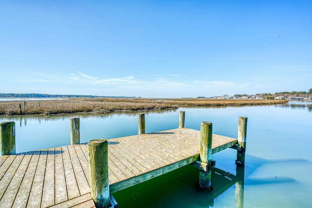 Rare chance to own buildable waterfront land on Chincoteague Island with direct access to the Assateague Channel. Enjoy sweeping views of the Channel, nearby creeks, and the Assateague Lighthouse. The property includes a 2-bedroom septic (as is), private dock, and bulkhead, offering an ideal setting for your custom coastal retreat. Launch kayaks or paddleboards from your backyard and take in wildlife and unforgettable sunsets. Close to the vibrant Chincoteague Island community, known for its local shops, dining, beaches, and nature trails.