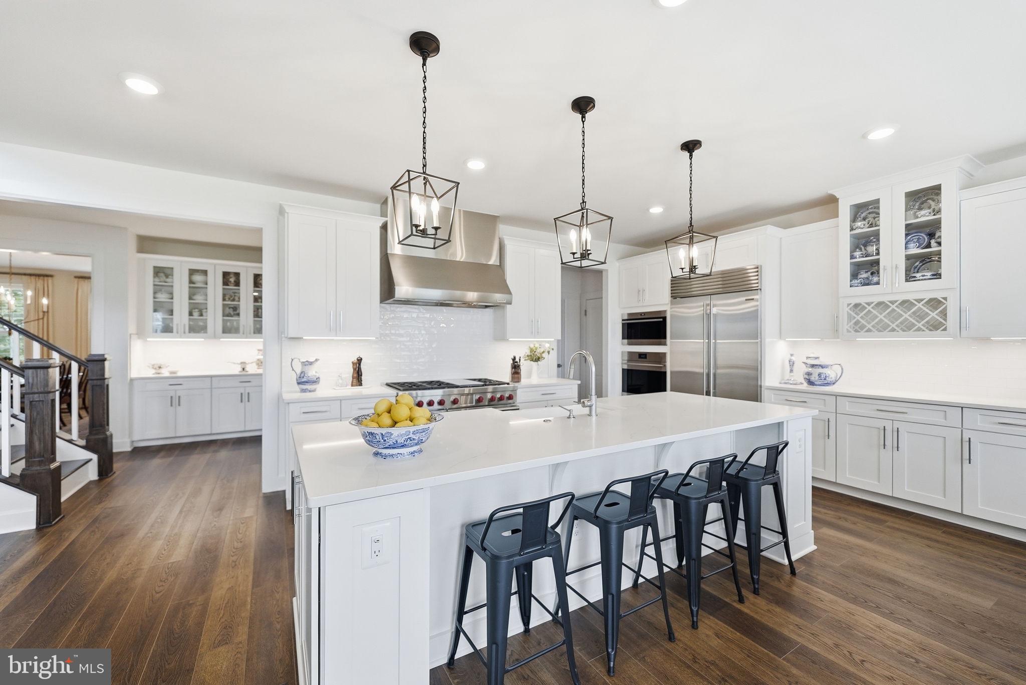 Welcome to an exceptional residence in Hartland, where thoughtful design, refined finishes, and uncompromising attention to detail come together. No detail has been spared in creating this extraordinary home, offering an elevated living experience with luxurious spaces designed for both everyday living and effortless entertaining.At the heart of the home is this spectaular gourmet kitchen which is  beautifully appointed for the most discerning chef. A 6-burner Wolf range takes center stage, complemented by a Sub-Zero refrigerator and a double wall oven,  generous preparation space, and exceptional storage. The kitchen is further enhanced by the spacious walk-in pantry and elegant **butler’s pantry, providing the perfect combination of function, organization, and style.The home’s private bedroom suites offer an exceptional level of comfort and privacy, with every bedroom featuring its own en-suite bathroom and walk-in closet. Whether hosting guests or enjoying quiet personal retreats, each space has been thoughtfully designed to feel both luxurious and inviting.Life in Hartland offers an exceptional array of amenities including miles of scenic walking and nature trails, the Hartland House with its outdoor pool and gym, a playground, tennis courts, and the nearby **Old Farm Winery**—creating an ideal setting for an active, connected, and truly enjoyable lifestyle.This is more than a beautiful home, it is a meticulously designed residence where luxury, functionality, and timeless style come together in one of Hartland’s most desirable settings. Schedule a tour today!
