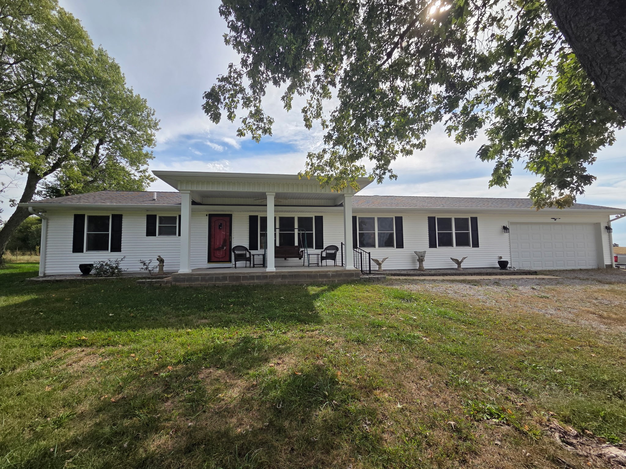 Don't miss out on this home with many amenities. Completely custom updated in 2013. Located on approximately 5 acres and only 2.5 miles from town, this home has 4 bedrooms, 3 full baths and 2 kitchens with a mother-in-law addition. The main bedroom and the bedroom in the M-I-L have washer/dryer connections in the walk-in closets for handy wash/dry and store. There are 2 gas fireplaces in the home, one located in the living room and one in the dining room. And don't miss the sunroom located in the middle of the home, just off of the kitchen. Dining, Kitchen and Sunroom all designed to see completely through the home from front to back with no obstructed views. Property has a 2400 sq ft outbuilding (40 x 60) with a 450 sq ft office (15 X 30 heated and cooled). This is a "pass through" garage with 14ft doors on each end. Garage has lots of room for storage, including much room over the office inside the garage. There are several other smaller storage buildings on the property that can stay or be moved depending on the buyer's preference. Backyard has a 4ft above ground pool with several accessories which has been leveled and landscaped. The doors in the home are handicap accessible with most being 3ft wide. The house has a Generac generator that supplies power throughout the home. The home electric is 400 amp service and the garage has a 200 amp service. The septic system was recently pumped in 2024. Buyer or buyer's agent to verify all measurements including survey.