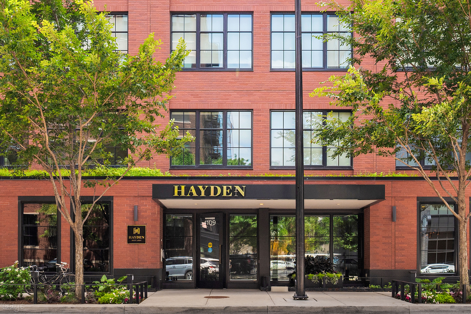 Welcome to the crown jewel of the iconic Hayden boutique building in the heart of the West Loop! Featured in Interiors Magazine, this extraordinary duplex-up penthouse is one of the largest floor plans in the building, spanning two breathtaking levels with over 5,000 square feet of living space, with private dual-elevator access, soaring ceilings, and walls of windows that flood every inch of the home with natural light and offer sweeping views of the city. Professionally designed by Judy Olson Dunne of Butter and Eggs, and meticulously elevated by its current owners with no detail overlooked and no expense spared, this is not just a home but a true architectural showpiece! At the heart of it all is a kitchen that redefines what luxury cooking looks like, featuring a 60-inch Wolf and Sub-Zero refrigerator-freezer, a full suite of high-end Wolf and Sub-Zero appliances, a stunning combination of leathered quartzite, butcher block, and zinc countertops, and a custom-built-in hood as a true focal point. A dedicated scullery with 2 wine fridges makes this kitchen as functional as it is beautiful, with exceptional storage throughout. Designer lighting elevates every corner of the home, and custom built-ins have been thoughtfully integrated throughout in closets, living areas, and beyond, all executed at the highest level. The expansive family room anchors the main level with a beautifully appointed built-in gas fireplace, and a gracious separate dining space completes the entertaining flow. Open your wall of windows to create indoor-outdoor living, and step outside to the professionally landscaped deck, designed by Botanical Concepts, complete with concrete pavers, custom planters, a built-in grill, and irrigation, creating an outdoor sanctuary above the city. Two additional bedrooms round out the main level, one a perfect private office or gym complete with a sauna, the other transformed into a stunning library with a custom-built-in bar with marble countertops and a beverage fridge. Escape upstairs to the bedroom level, where the primary suite is extraordinarily generous, outfitted with custom built-ins, a dream walk-in closet outfitted with custom Italian cabinets, and a spa-caliber bath featuring heated floors, a steam shower, a double vanity, and finishes that are wholly bespoke, the result of owners who spared nothing in making this home their own. Two additional spacious bedrooms are en suite, including one beautifully appointed and covered in grasscloth wallpaper, a second living space that could easily be converted into an additional bedroom, and a dedicated nook reimagined as a custom library. A generous laundry room on the upper level, with additional closets and a convenient secondary entrance, provides seamless everyday functionality. Two deeded garage parking spaces and a fully automated Crestron system controlling sound, lighting, HVAC, and Lutron throughout round out this extraordinarily considered home. Exceptional location in the heart of the West Loop, steps from the neighborhood's most celebrated dining and culture, including Girl & the Goat, Monteverde, Au Cheval, Aba, Trivoli Tavern, Bar Tutto, Trino, and ample parks for the pup, including Mary Bartleme Park. Do not miss the rare opportunity to own this one-of-a-kind penthouse that is a true masterpiece!